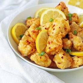 Chinese Lemon Chicken made with crispy fried chicken covered in an authentic, fresh lemon sauce. The ultimate Chinese Lemon Chicken Recipe which is way better than take-out. www.modernhoney.com #chinesefood #asianfood #lemonchicken #chineselemonchicken