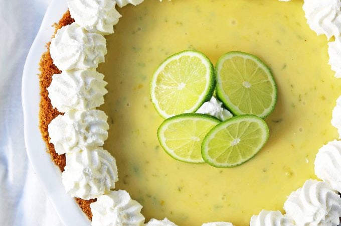 Key Lime Pie. The best creamy key lime pie in a buttery graham cracker crust with fresh sweetened whipped cream. www.modernhoney.com #keylimepie #limepie #pie #easterdesserts
