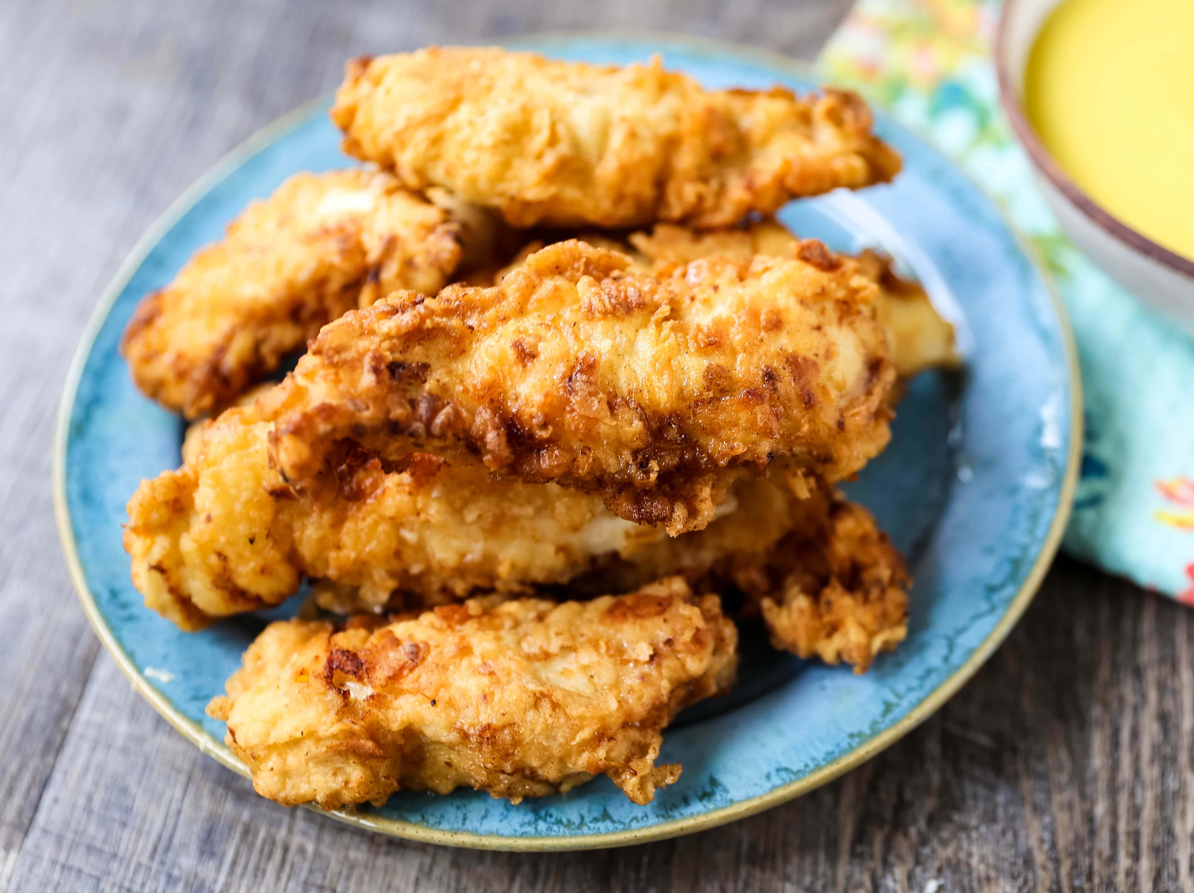 Fried Chicken Tenders Juicy, tender, marinated chicken dipped in coating and fried until perfectly crispy. The best fried chicken tenders recipe! www.modernhoney.com #chicken #chickentenders #friedchicken #friedchickentenders