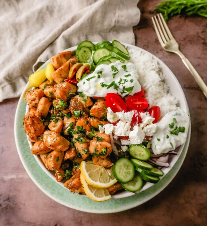 How to make the Best Greek Chicken Bowls. Grilled Greek Lemon Chicken, cucumber, tomatoes, red onion, kalamata olives, feta cheese, and homemade tzatziki sauce all in one bowl. A high-protein and low-carb meal!