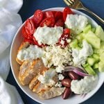 Greek Chicken Bowls. Grilled Greek Lemon Chicken, cucumber, tomatoes, red onion, kalamata olives, feta cheese, and homemade tzatziki sauce all in one bowl. A high-protein and low carb meal! www.modernhoney.com #greekchickenbowls #greekchickenbowl #greekfood #glutenfree