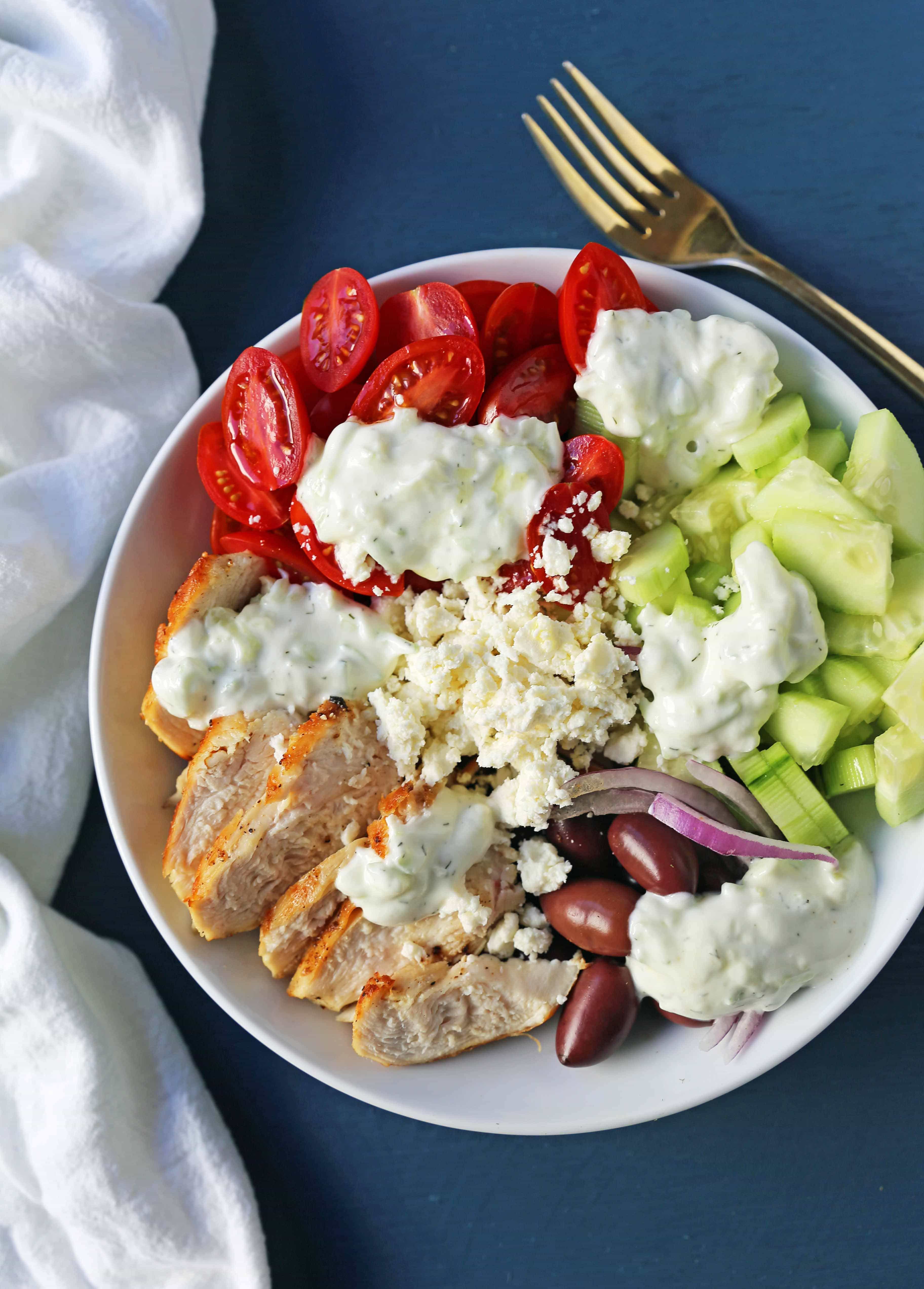 Greek Chicken Bowls. Grilled Greek Lemon Chicken, cucumber, tomatoes, red onion, kalamata olives, feta cheese, and homemade tzatziki sauce all in one bowl. A high-protein and low carb meal! www.modernhoney.com #greekchickenbowls #greekchickenbowl #greekfood #glutenfree