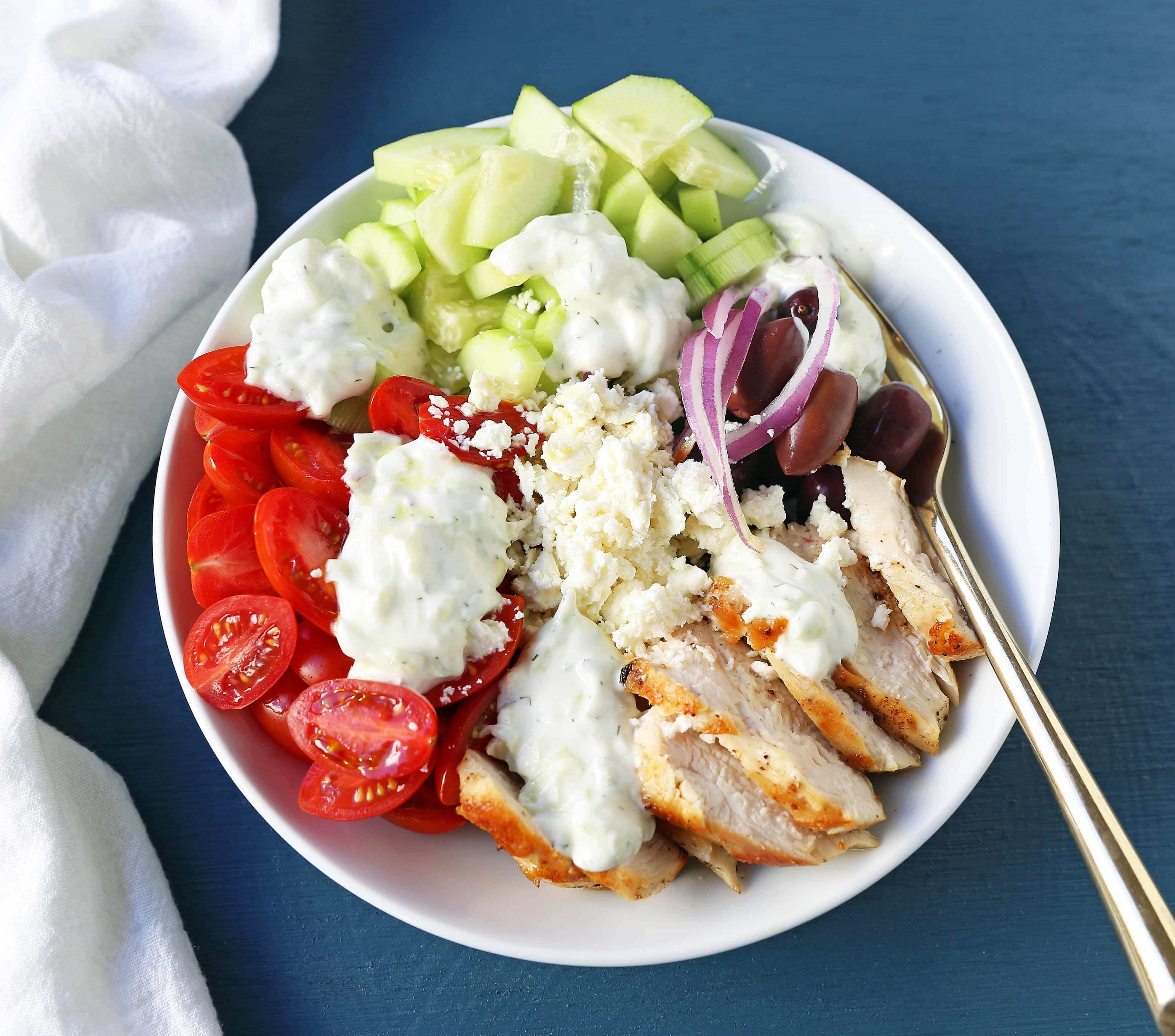 Greek Chicken Bowls. Grilled Greek Lemon Chicken, cucumber, tomatoes, red onion, kalamata olives, feta cheese, and homemade tzatziki sauce all in one bowl. A high-protein and low carb meal! www.modernhoney.com #greekchickenbowls #greekchickenbowl #greekfood #glutenfree
