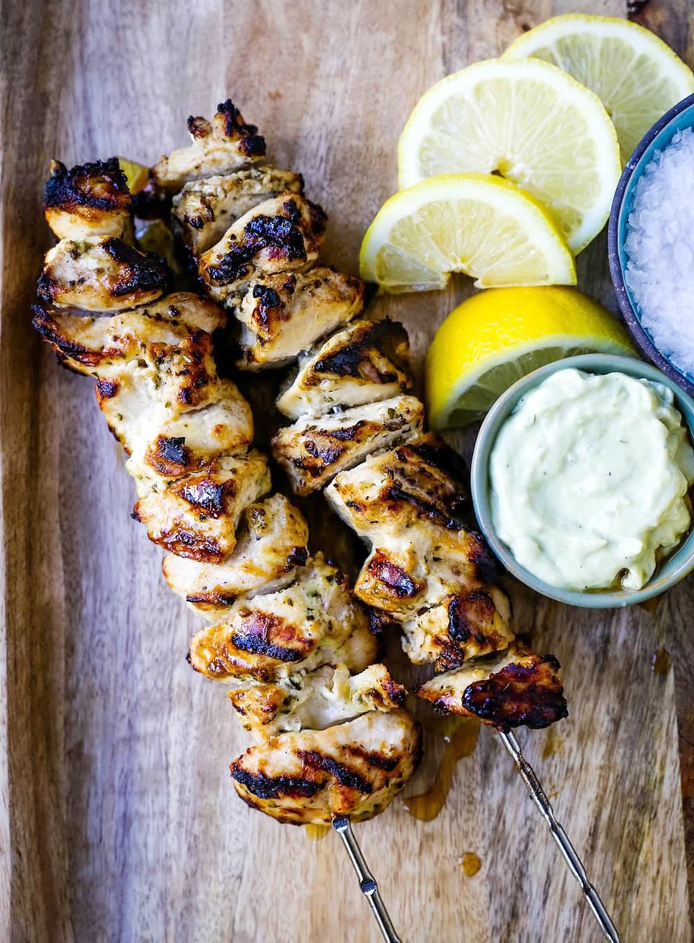 Greek Chicken Kabobs Yogurt marinated and Greek spiced chicken grilled to perfection and dipped in homemade tzatziki sauce. www.modernhoney.com #greek #greekfood #chickenkabobs #greekchickenkabobs