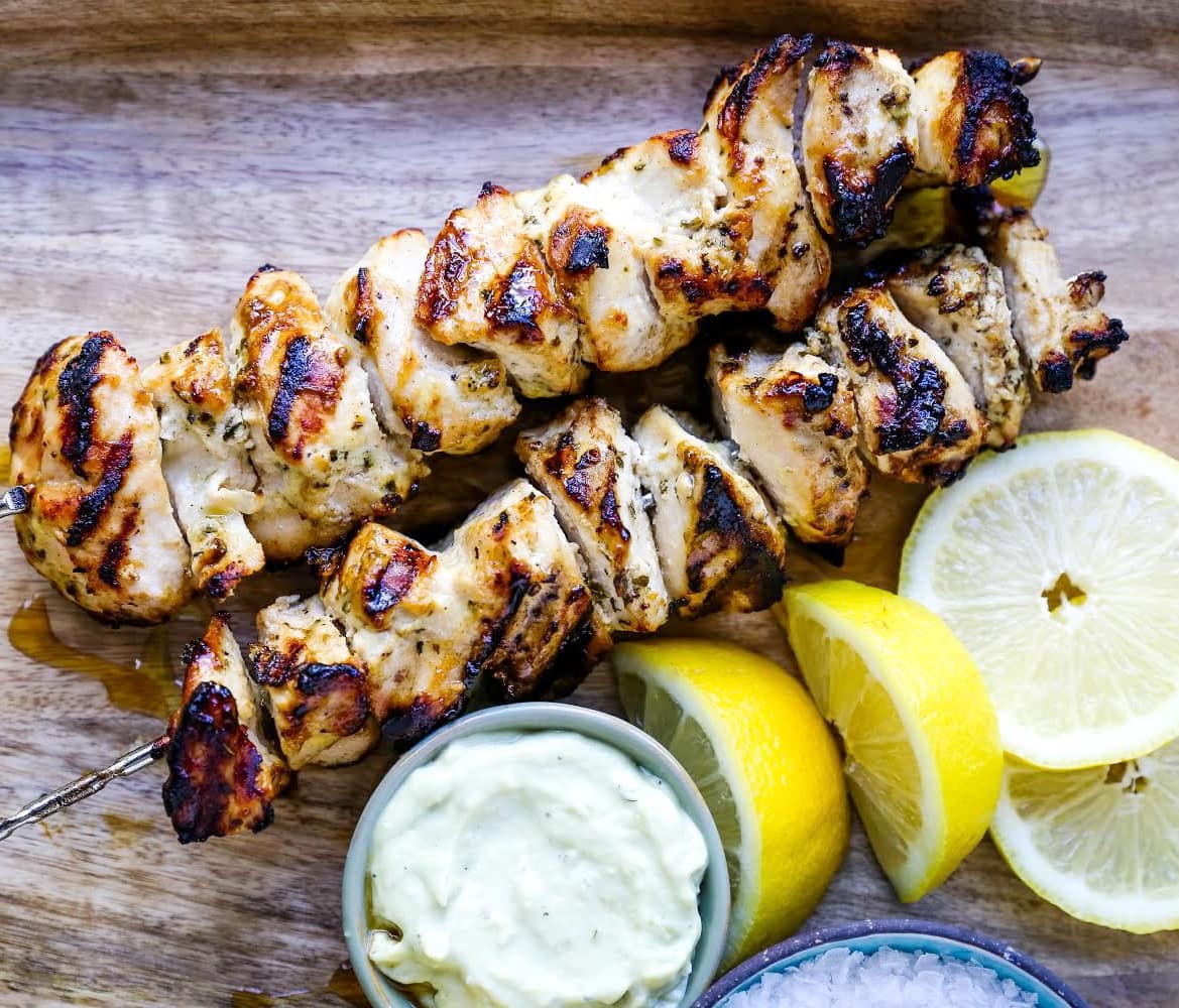 Greek Chicken Kabobs Yogurt marinated and Greek spiced chicken grilled to perfection and dipped in homemade tzatziki sauce. www.modernhoney.com #greek #greekfood #chickenkabobs #greekchickenkabobs