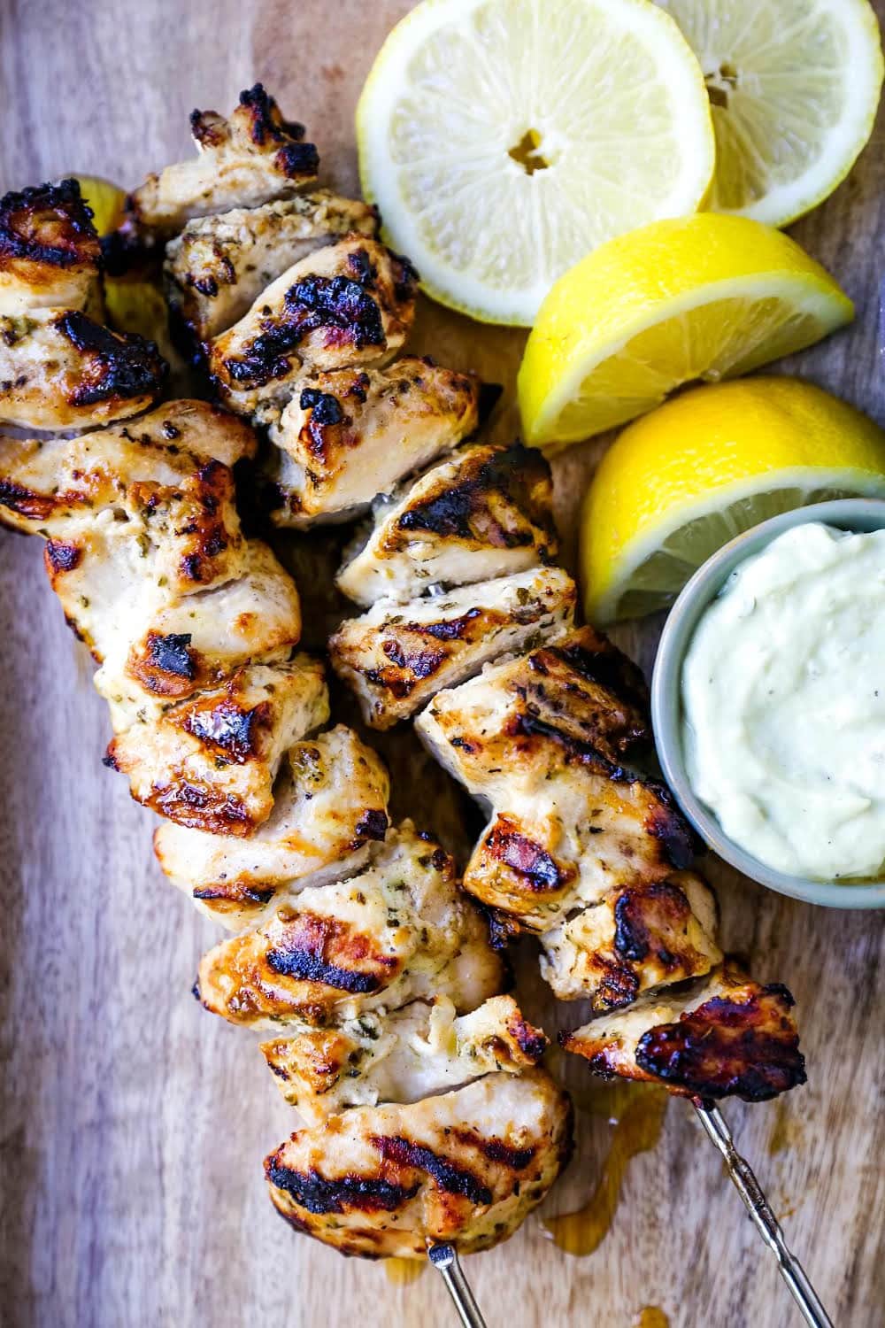 Greek Chicken Kabobs Yogurt marinated and Greek spiced chicken grilled to perfection and dipped in homemade tzatziki sauce. www.modernhoney.com #greek #greekfood #chickenkabobs #greekchickenkabobs