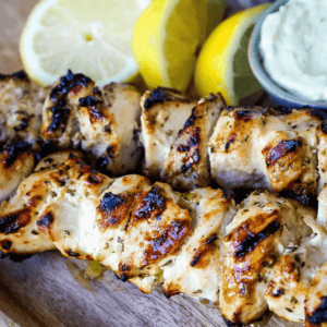 Greek Chicken Kabobs Yogurt marinated and Greek spiced chicken grilled to perfection and dipped in homemade tzatziki sauce. www.modernhoney.com #greek #greekfood #chickenkabobs #greekchickenkabobs