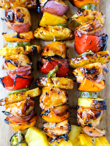 Hawaiian Teriyaki Chicken Skewers Grilled chicken skewers with peppers, onions, pineapple, and jalapeño basted in a sweet and salty teriyaki sauce and grilled to perfection. www.modernhoney.com #chickenskewers #chickenkabobs #teriyakichicken
