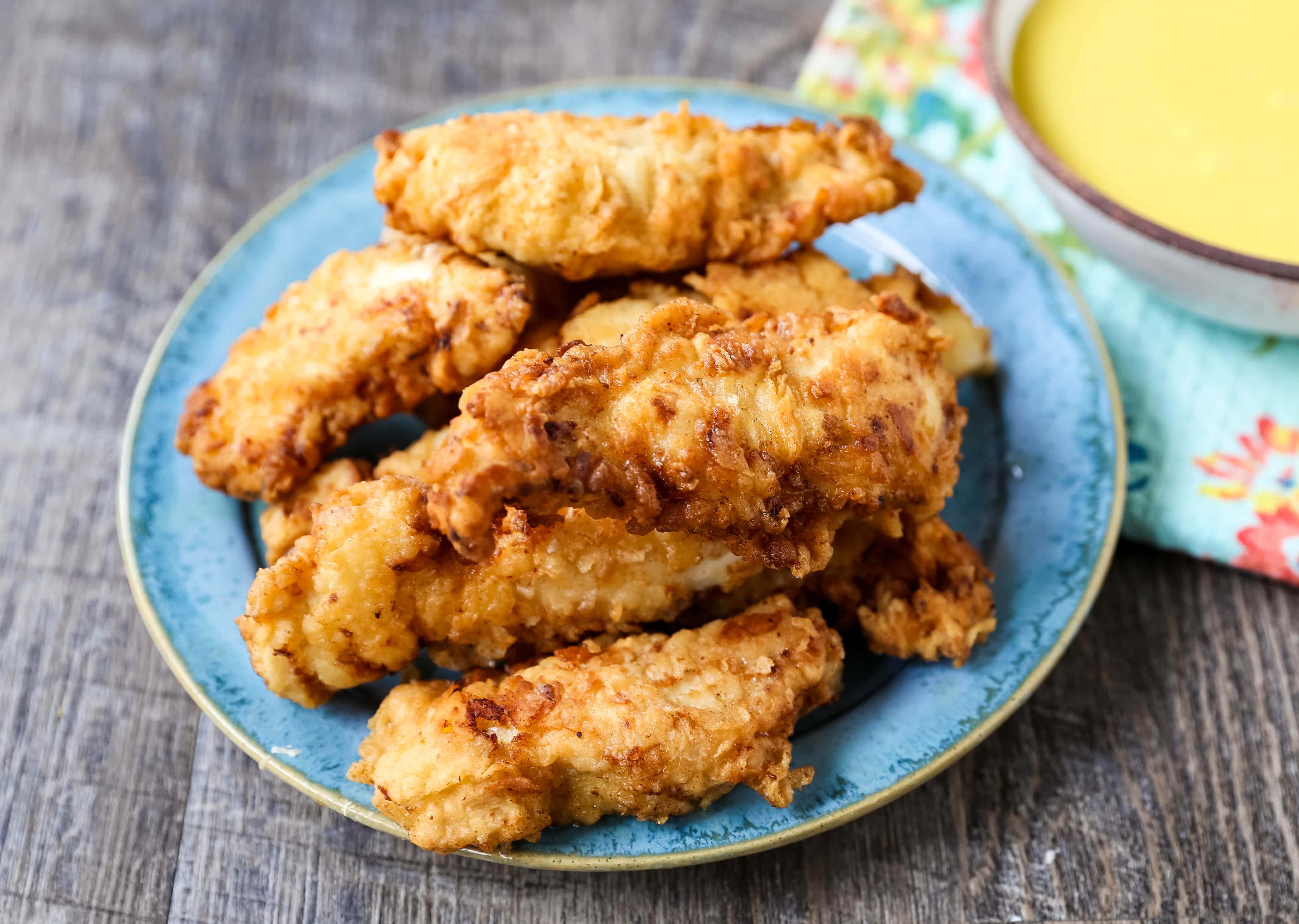 Fried Chicken Tenders Juicy, tender, marinated chicken dipped in coating and fried until perfectly crispy. The best fried chicken tenders recipe! www.modernhoney.com #chicken #chickentenders #friedchicken #friedchickentenders