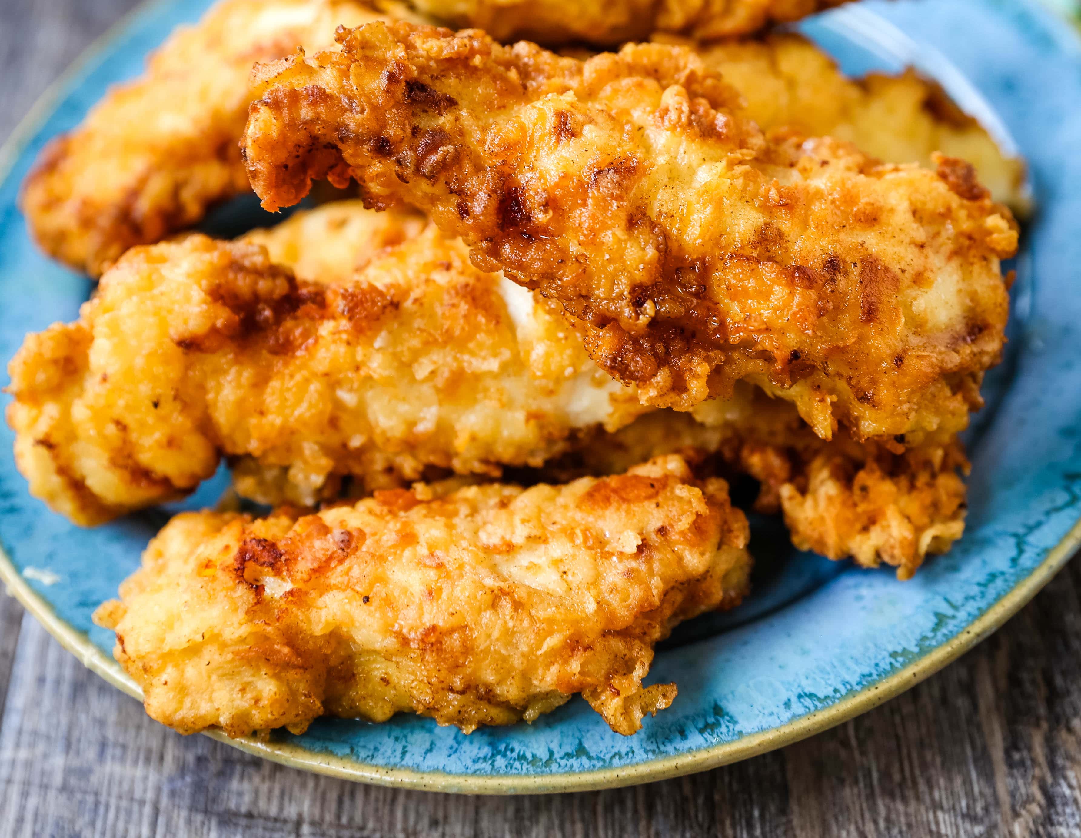 Fried Chicken Tenders Juicy, tender, marinated chicken dipped in coating and fried until perfectly crispy. The best fried chicken tenders recipe! www.modernhoney.com #chicken #chickentenders #friedchicken #friedchickentenders