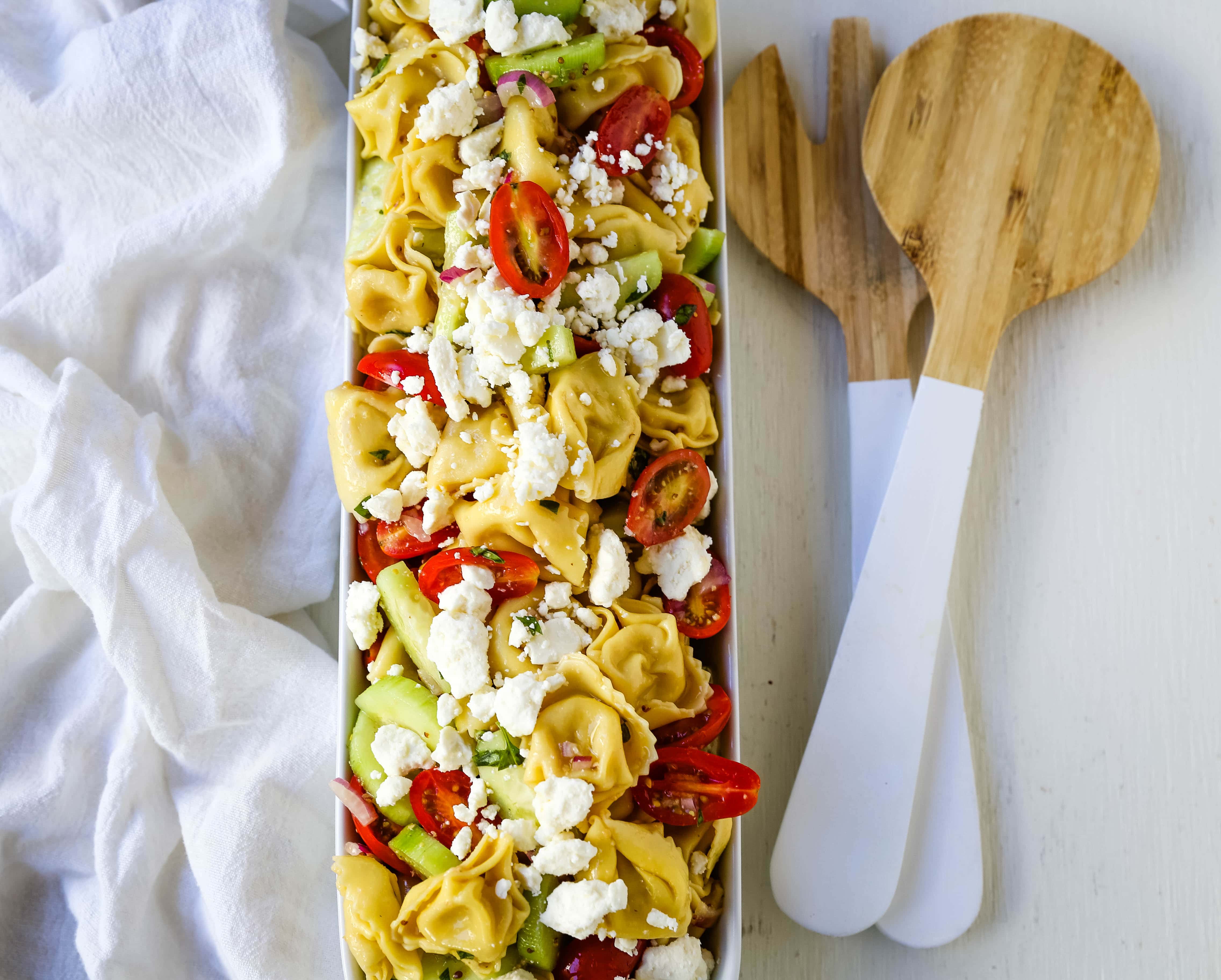 Greek Tortellini Pasta Salad. Cheese Tortellini Pasta tossed with fresh tomatoes, cucumbers, red onion, feta cheese, in a homemade Greek dressing. www.modernhoney.com #sidedish #pastasalad #salad #potluck