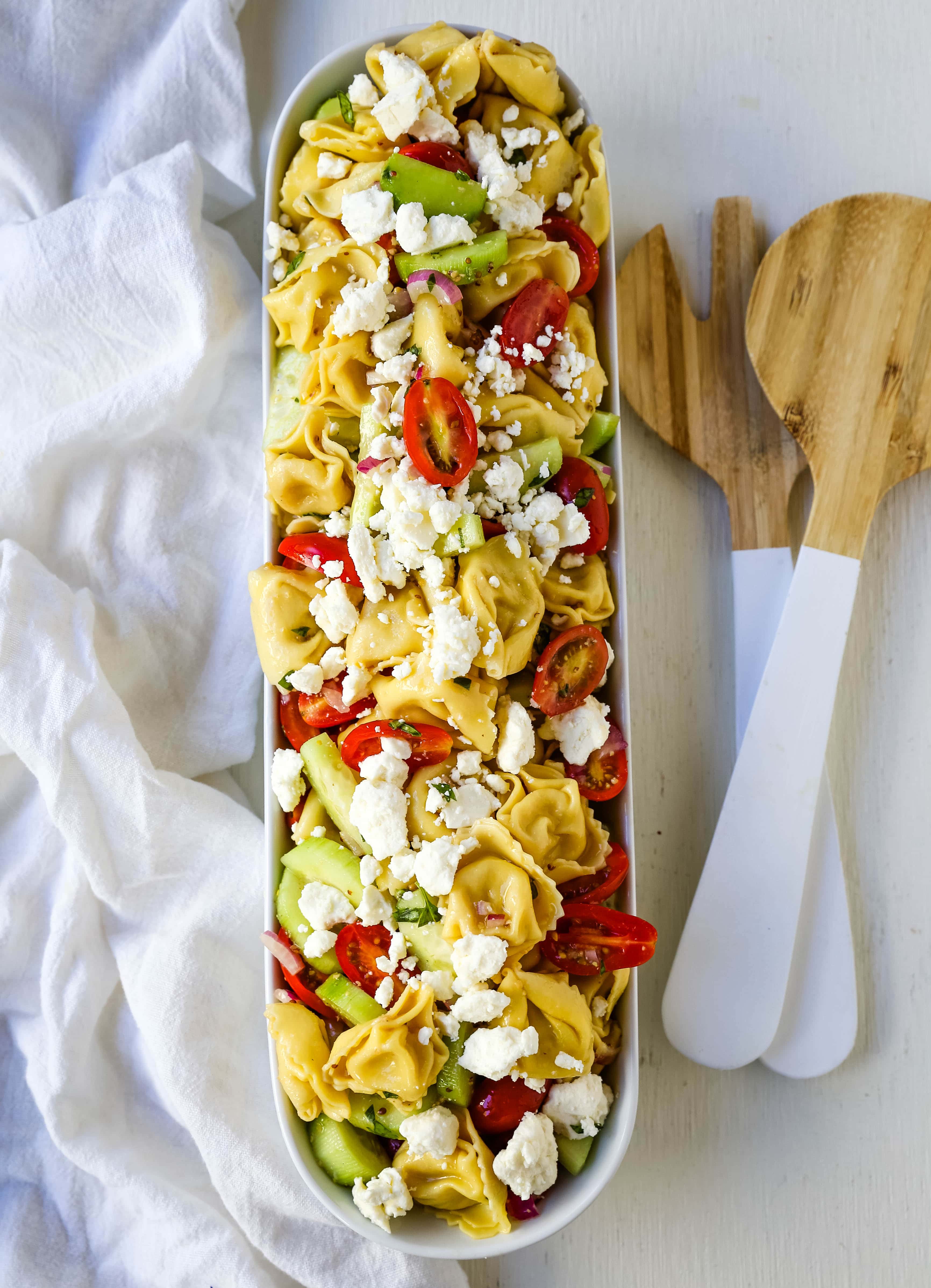 Greek Tortellini Pasta Salad. Cheese Tortellini Pasta tossed with fresh tomatoes, cucumbers, red onion, feta cheese, in a homemade Greek dressing. www.modernhoney.com #sidedish #pastasalad #salad #potluck