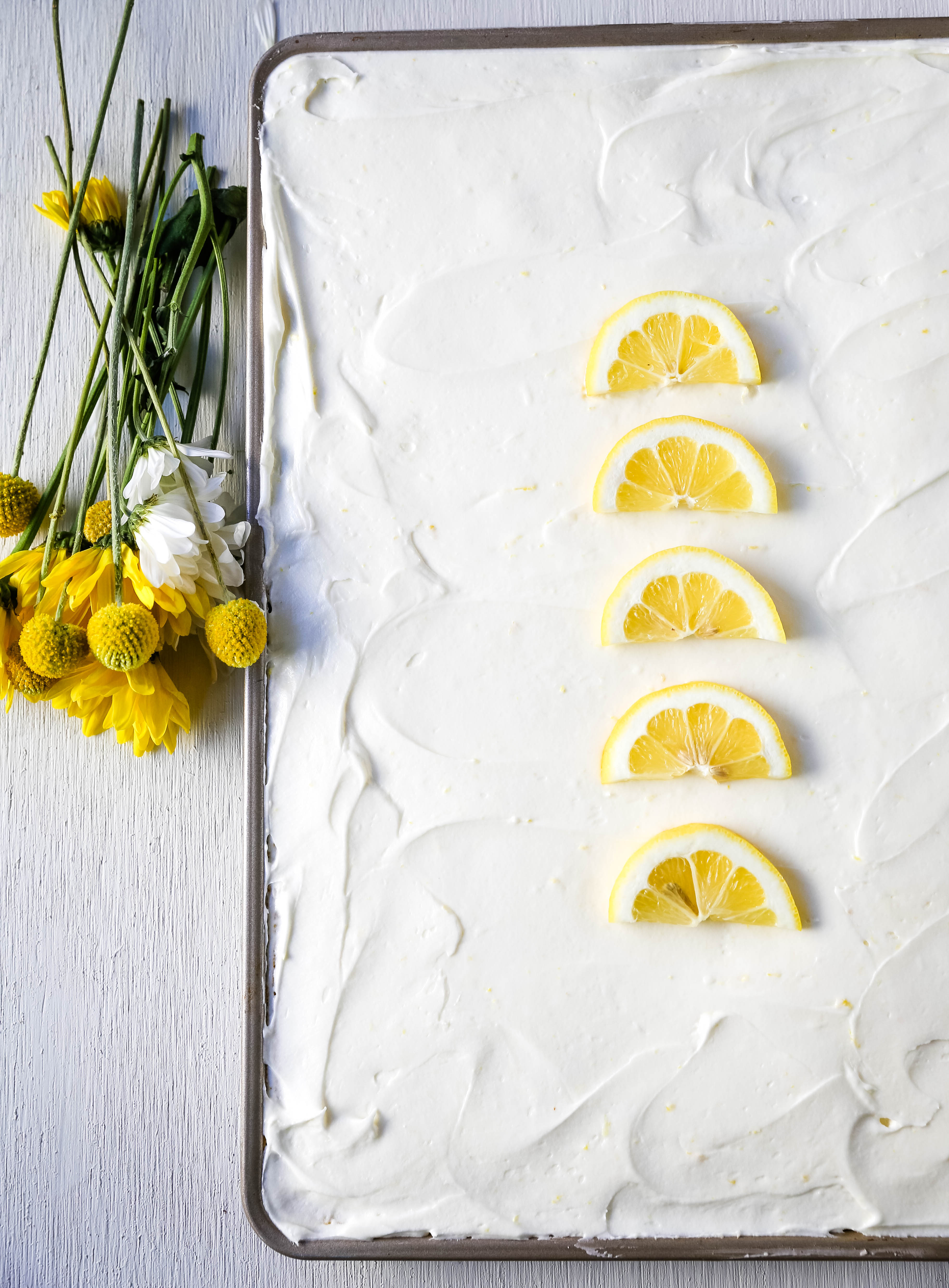 Lemon Sheet Cake Recipe. Moist sour cream lemon sheet cake recipe with a fresh lemon cream cheese frosting. #lemonsheetcake #cake