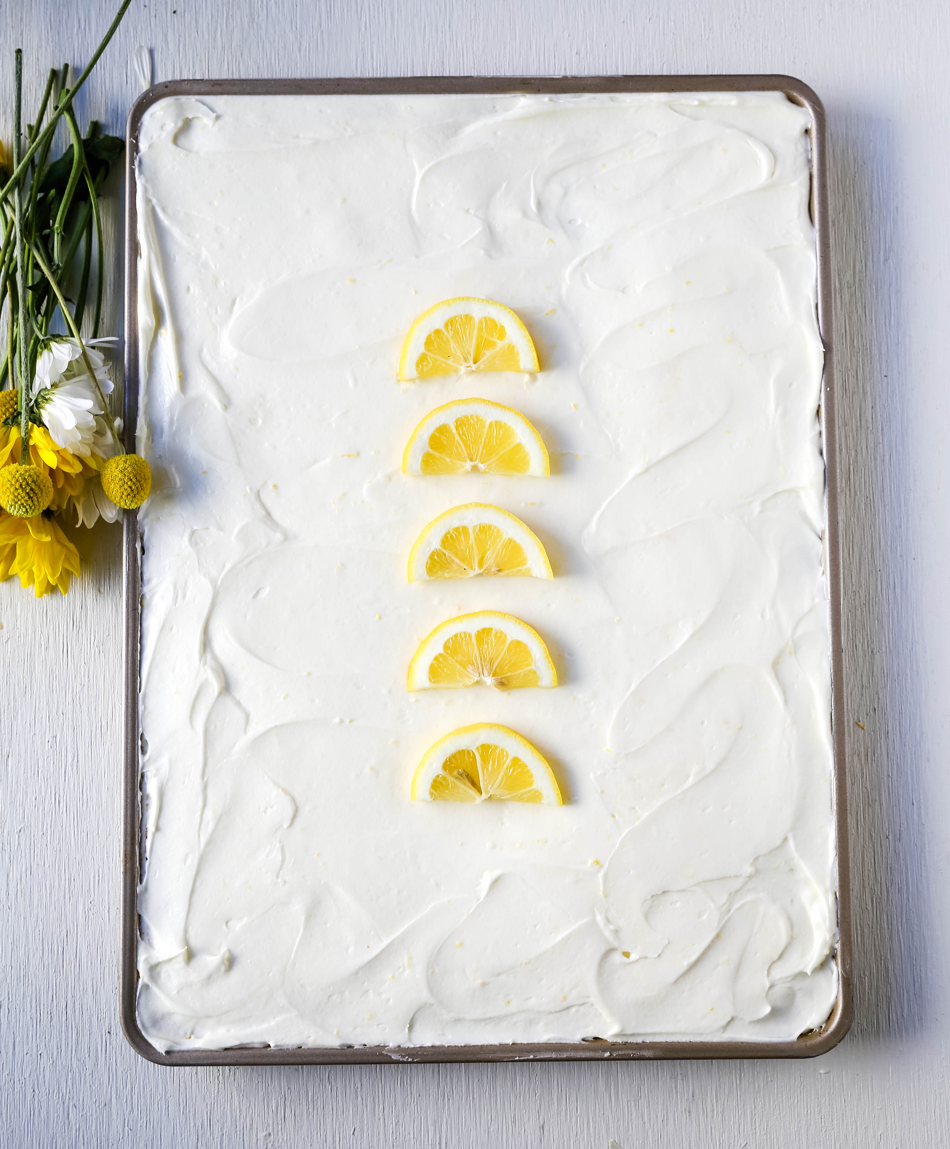 Lemon Sheet Cake Recipe. Moist sour cream lemon sheet cake recipe with a fresh lemon cream cheese frosting. #lemonsheetcake #cake