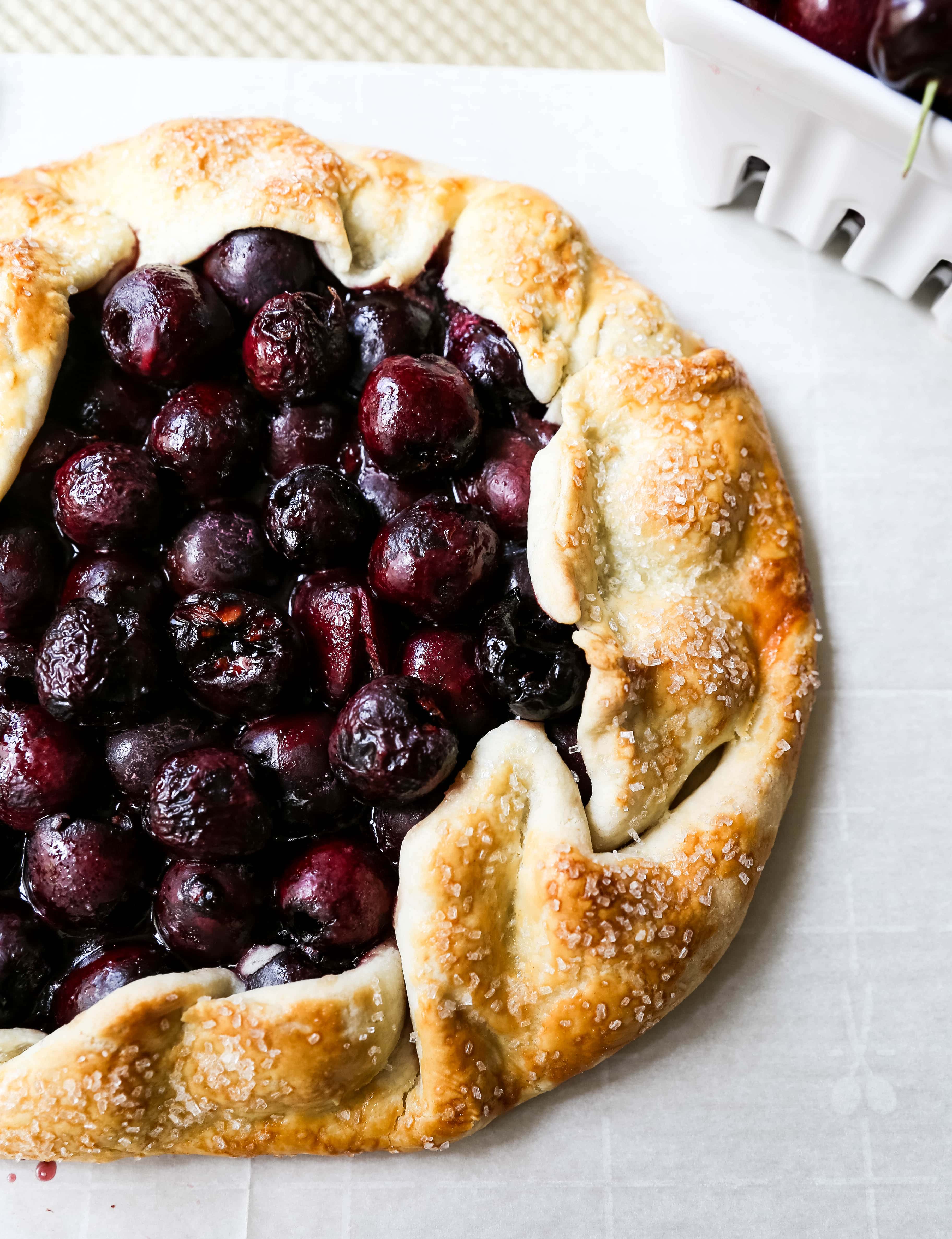 Cherry Galette. Fresh sweet cherries baked in a homemade rustic pie crust and topped with vanilla bean ice cream. The Best Cherry Crostata Recipe. www.modernhoney.com #cherrygalette #cherrycrostata #cherries #cherry #cherrydessert