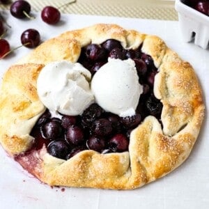 Cherry Galette. Fresh sweet cherries baked in a homemade rustic pie crust and topped with vanilla bean ice cream. The Best Cherry Crostata Recipe. www.modernhoney.com #cherrygalette #cherrycrostata #cherries #cherry #cherrydessert