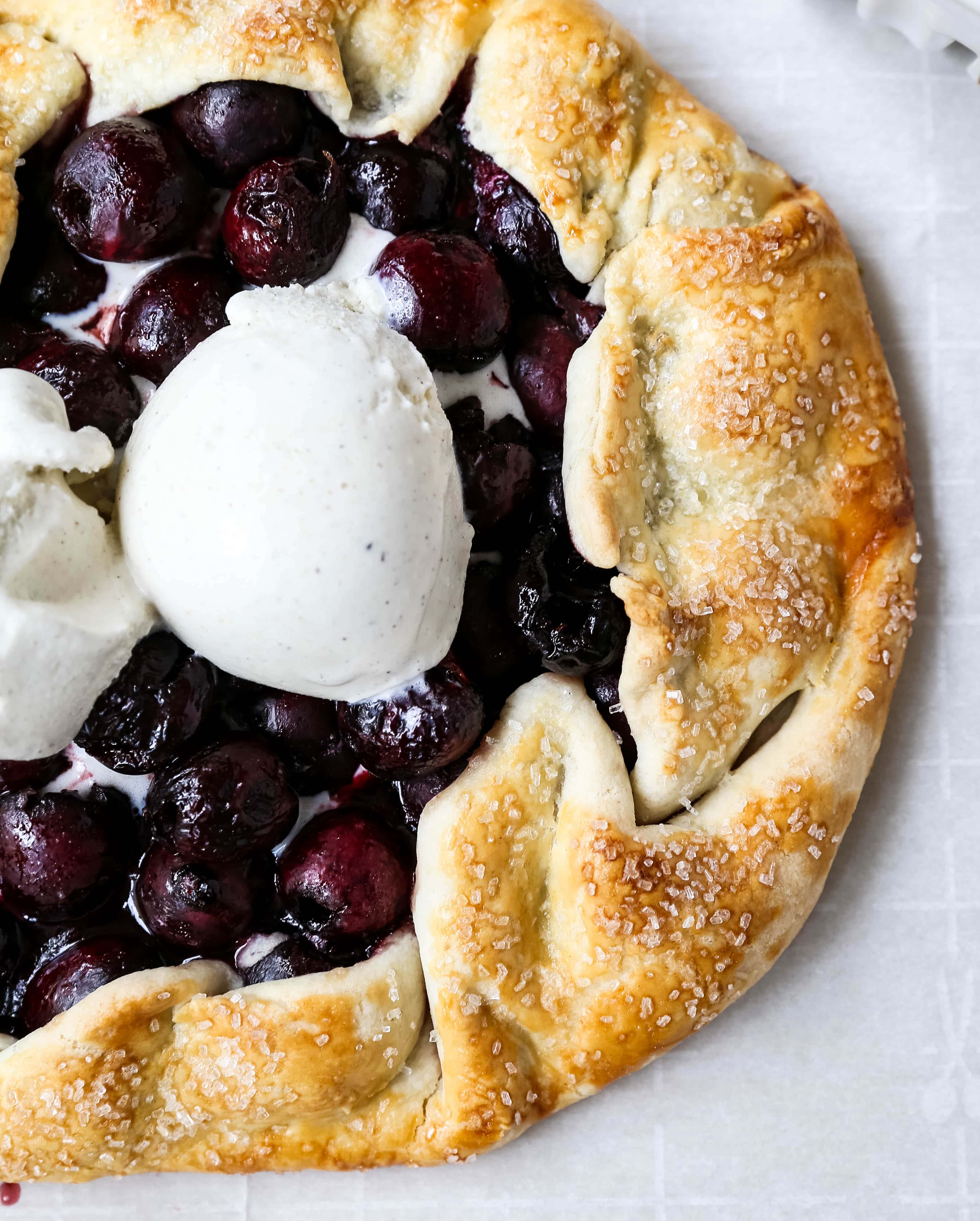 Cherry Galette. Fresh sweet cherries baked in a homemade rustic pie crust and topped with vanilla bean ice cream. The Best Cherry Crostata Recipe. www.modernhoney.com #cherrygalette #cherrycrostata #cherries #cherry #cherrydessert