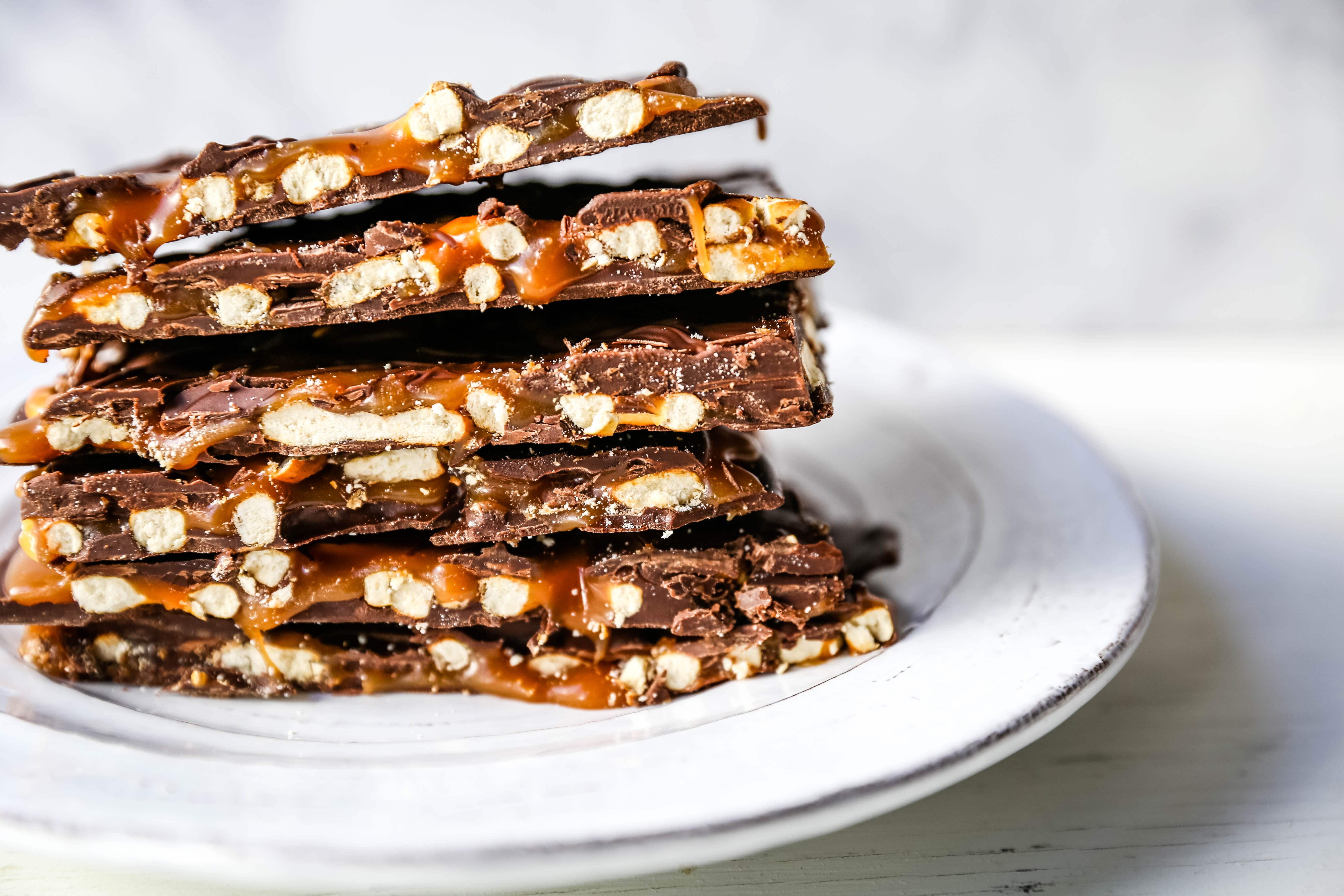 Chocolate Caramel Pretzel Bark. An easy homemade chocolate candy treat made with homemade salted caramel, salty pretzels, and creamy milk and semi-sweet chocolate. The perfect salty sweet combination! www.modernhoney.com #chocolatebark #pretzelbark #chocolatepretzelbark