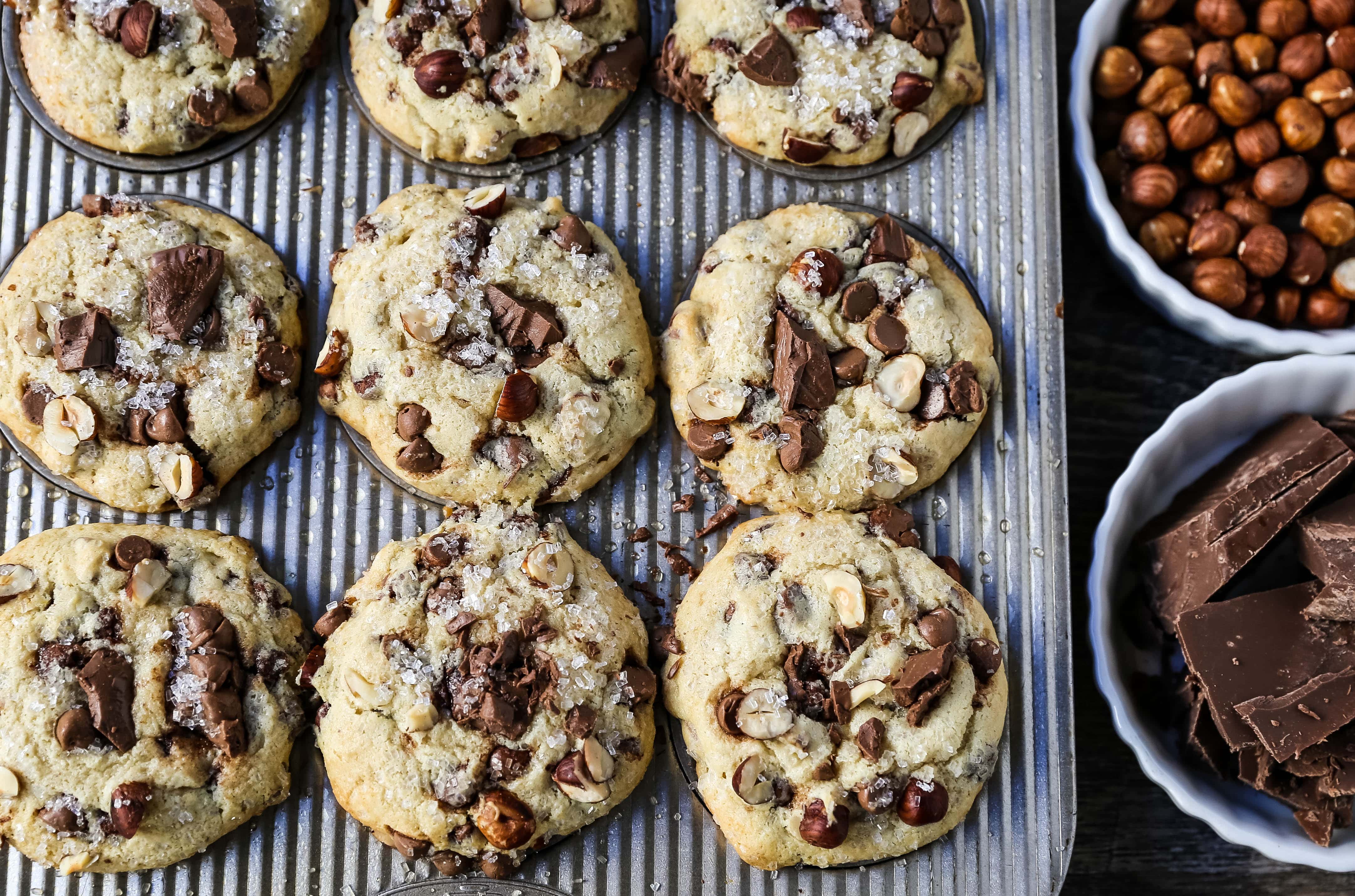 The Best Chocolate Chip Muffins. Chocolate Chunk Hazelnut Muffins with rich chocolate chips and crunchy hazelnuts. A gourmet bakery style muffin recipe. www.modernhoney.com #muffin #muffins #chocolatechipmmuffin #chocolatehazelnut