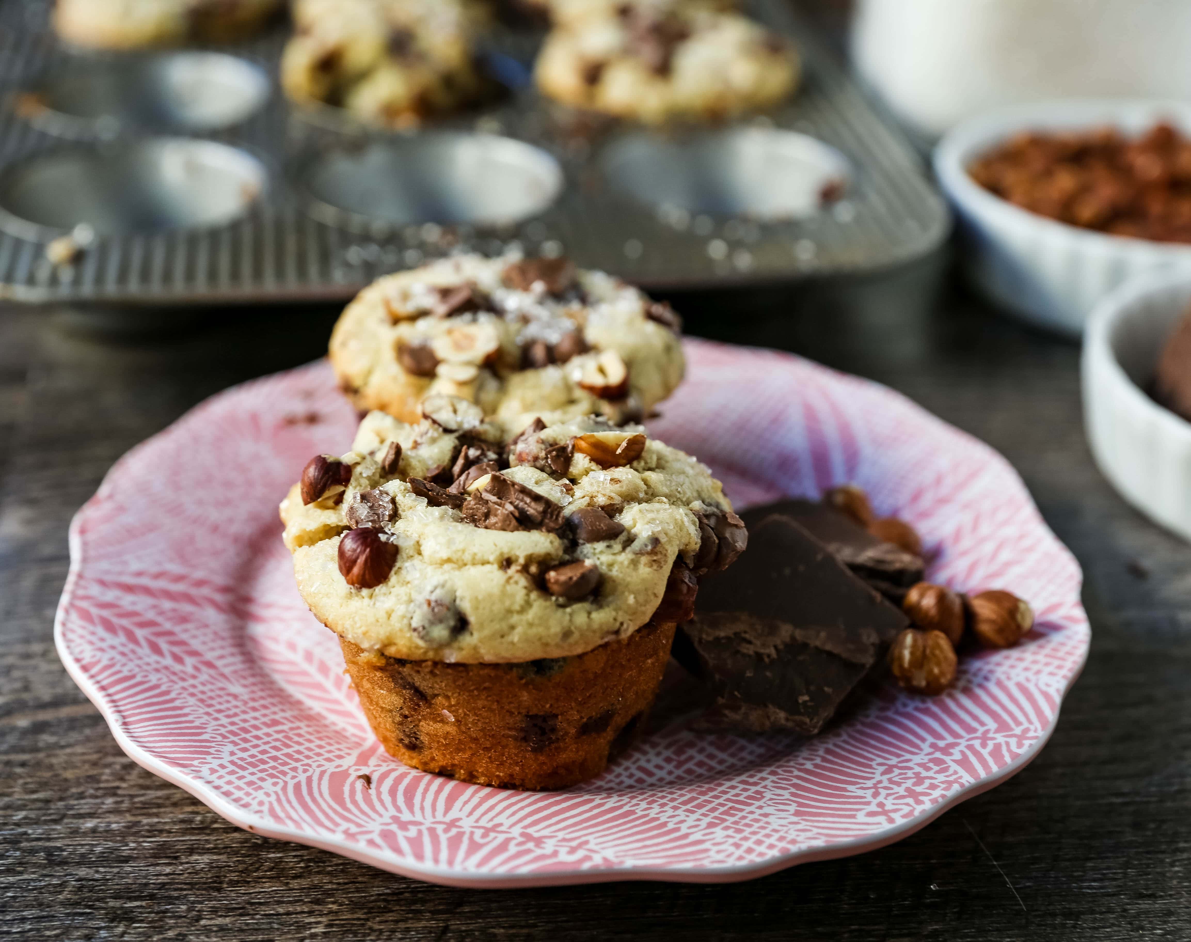 The Best Chocolate Chip Muffins. Chocolate Chunk Hazelnut Muffins with rich chocolate chips and crunchy hazelnuts. A gourmet bakery style muffin recipe. www.modernhoney.com #muffin #muffins #chocolatechipmmuffin #chocolatehazelnut