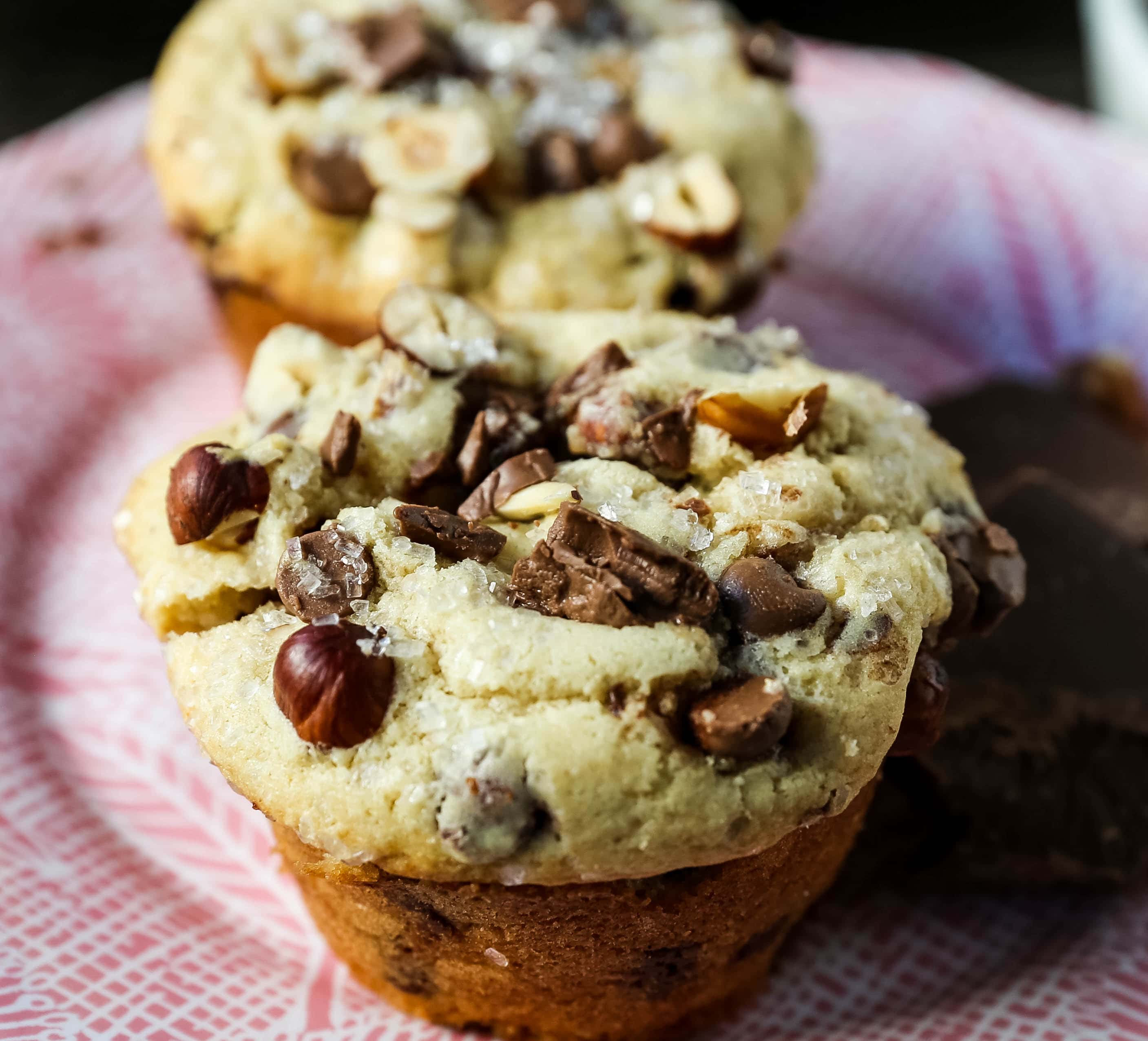The Best Chocolate Chip Muffins. Chocolate Chunk Hazelnut Muffins with rich chocolate chips and crunchy hazelnuts. A gourmet bakery style muffin recipe. www.modernhoney.com #muffin #muffins #chocolatechipmmuffin #chocolatehazelnut