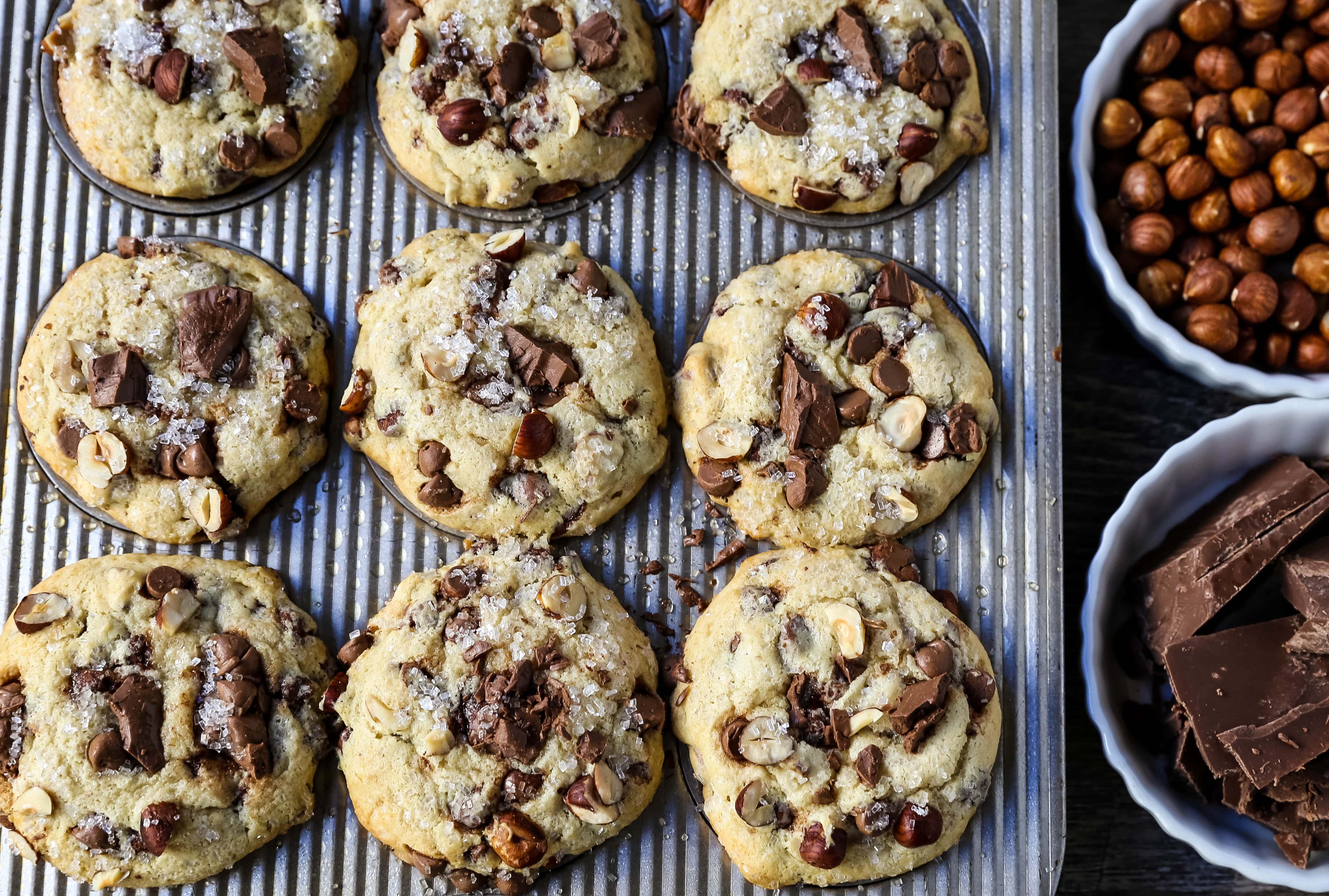 The Best Chocolate Chip Muffins. Chocolate Chunk Hazelnut Muffins with rich chocolate chips and crunchy hazelnuts. A gourmet bakery style muffin recipe. www.modernhoney.com #muffin #muffins #chocolatechipmmuffin #chocolatehazelnut