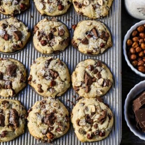 The Best Chocolate Chip Muffins. Chocolate Chunk Hazelnut Muffins with rich chocolate chips and crunchy hazelnuts. A gourmet bakery style muffin recipe. www.modernhoney.com #muffin #muffins #chocolatechipmmuffin #chocolatehazelnut