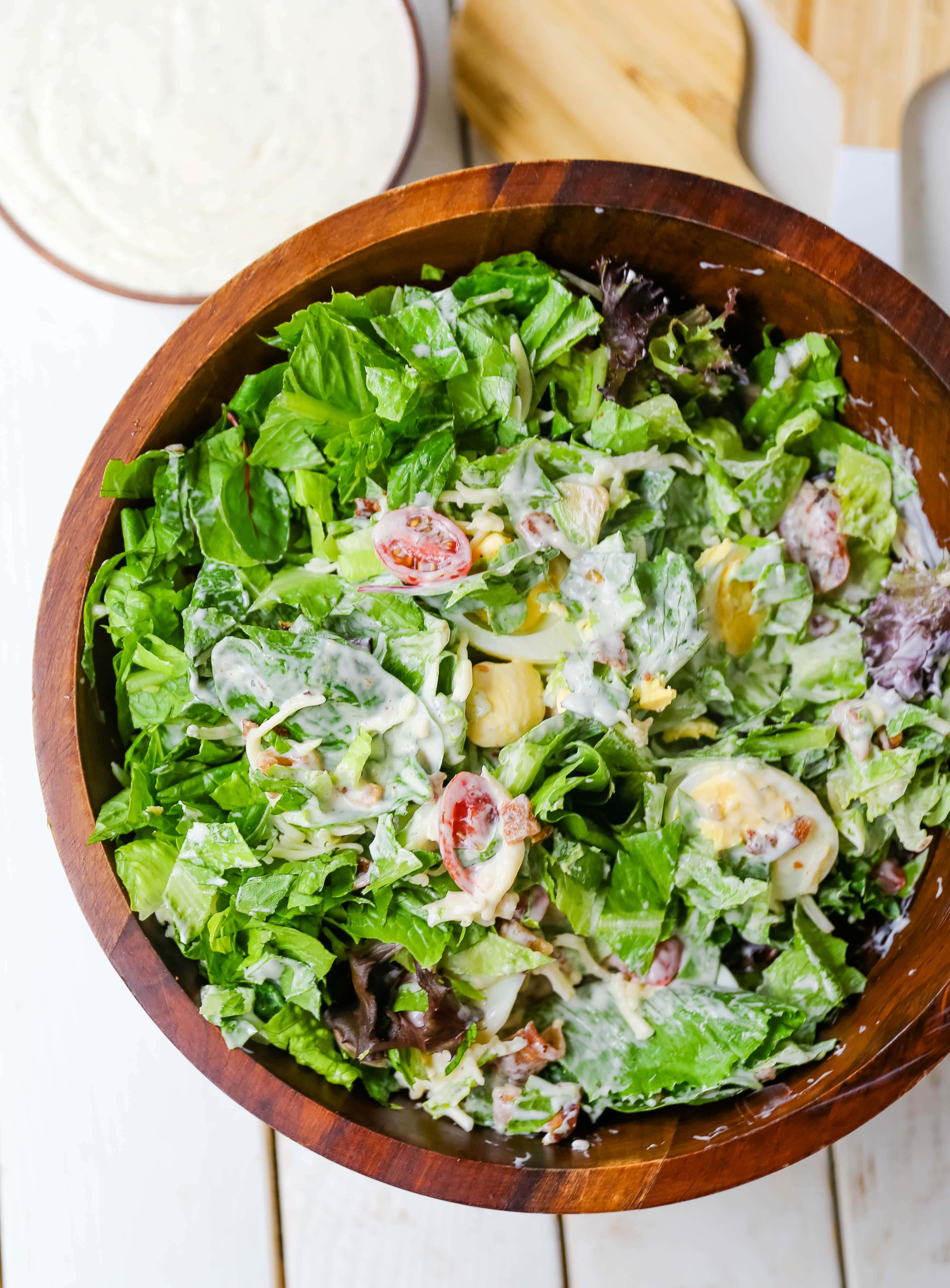 Cobb Salad made with romaine lettuce, crispy bacon, creamy avocado, juicy tomato, egg, Monterey Jack cheese, tossed in homemade Ranch dressing. www.modernhoney.com #salad #cobbsalad #salads