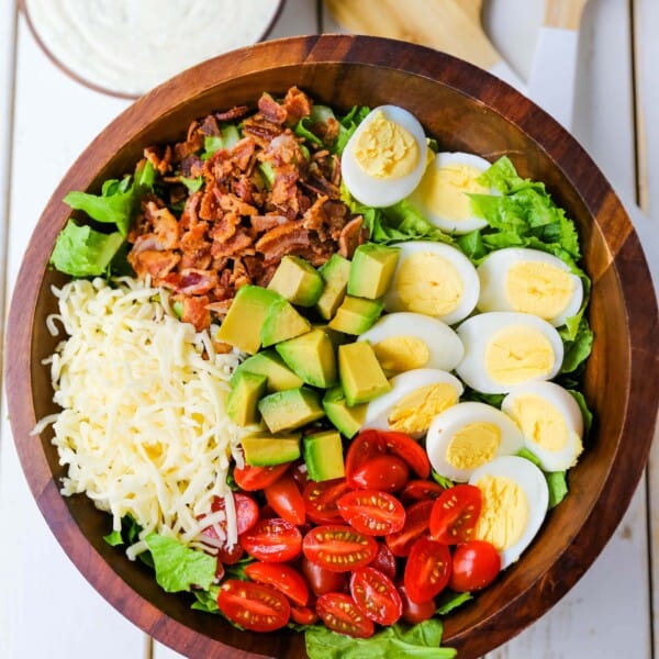 Cobb Salad made with romaine lettuce, crispy bacon, creamy avocado, juicy tomato, egg, Monterey Jack cheese, tossed in homemade Ranch dressing. www.modernhoney.com #salad #cobbsalad #salads