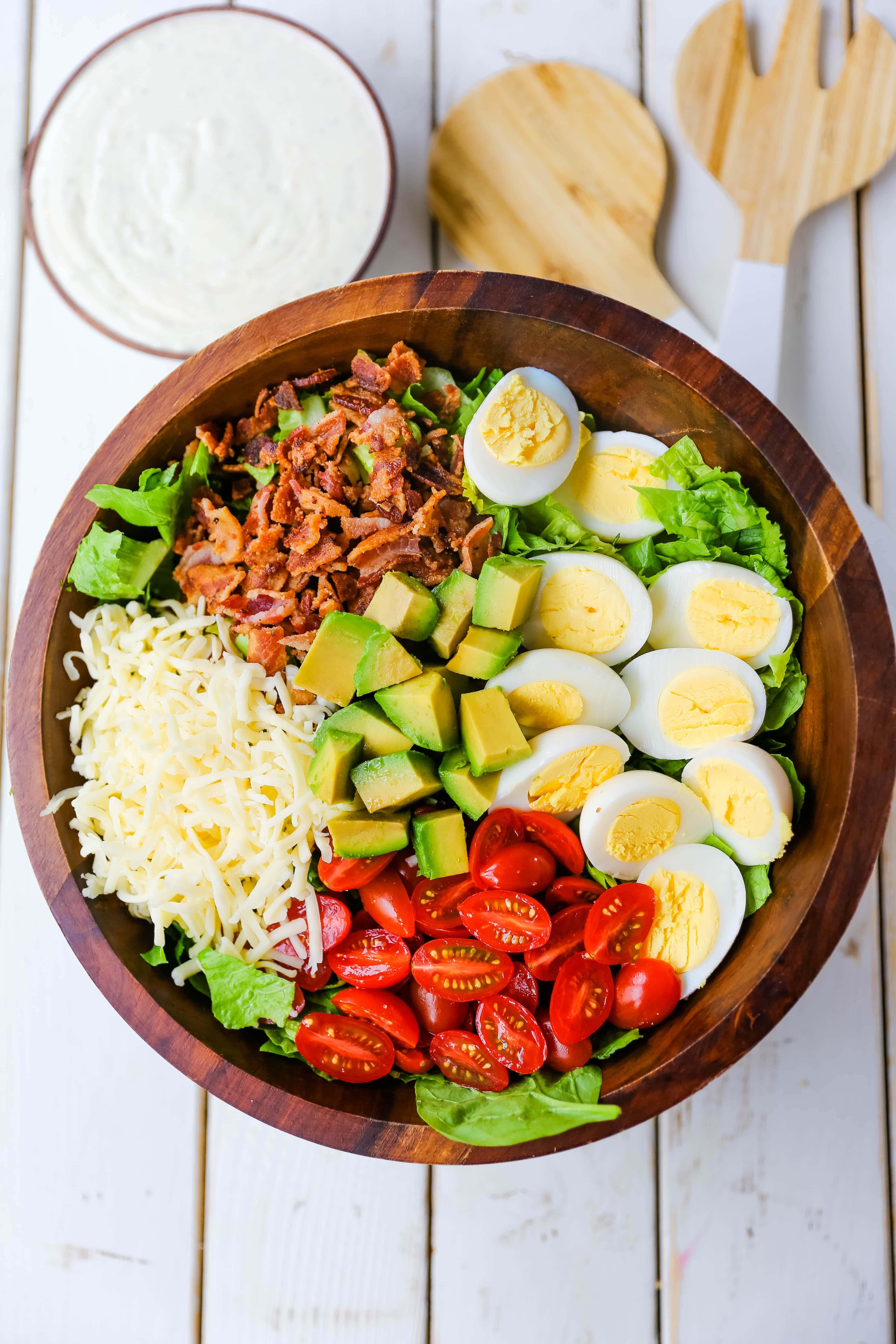 Cobb Salad made with romaine lettuce, crispy bacon, creamy avocado, juicy tomato, egg, Monterey Jack cheese, tossed in homemade Ranch dressing. www.modernhoney.com #salad #cobbsalad #salads