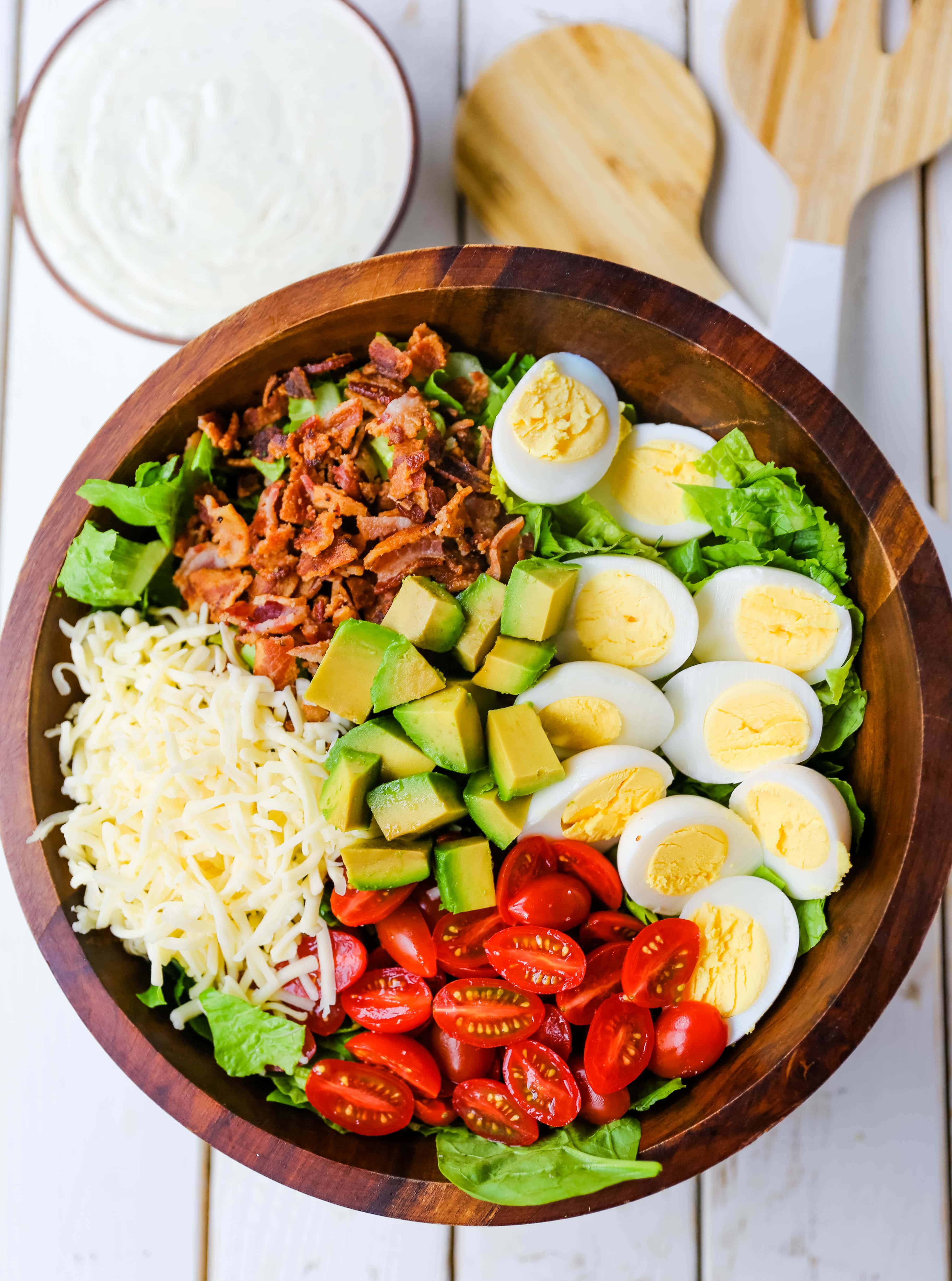 Cobb Salad made with romaine lettuce, crispy bacon, creamy avocado, juicy tomato, egg, Monterey Jack cheese, tossed in homemade Ranch dressing. www.modernhoney.com #salad #cobbsalad #salads