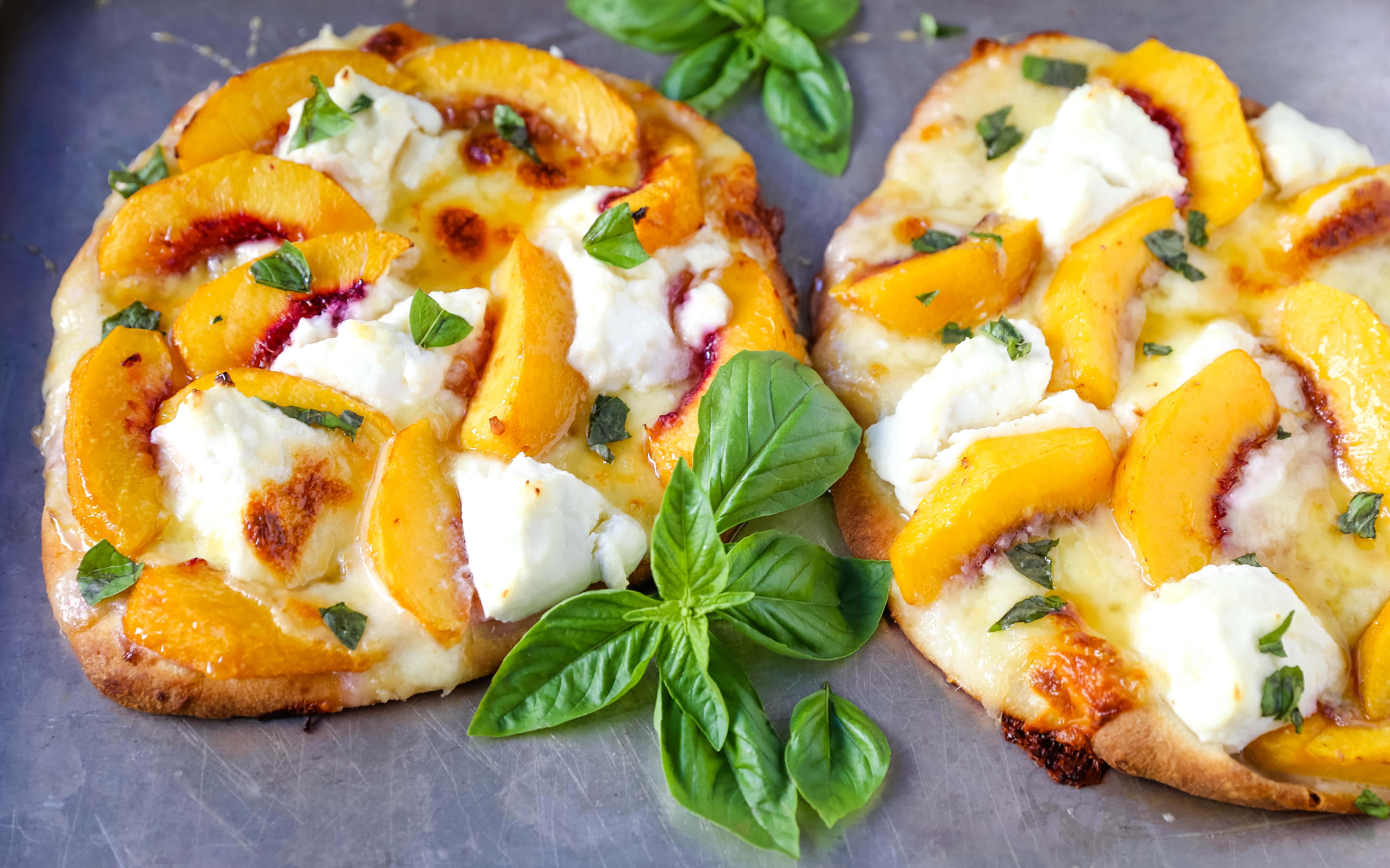 Peach Basil Mozzarella Flatbread Fresh peaches, basil ribbons, ricotta cheese, a drizzle of honey, fresh mozzarella all on a buttery flatbread. The perfect summer pizza!  www.modernhoney.com #peachpizza #flatbread #peachflatbread #summerpizza #peachrecipes