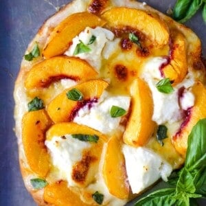 Peach Basil Mozzarella Flatbread Fresh peaches, basil ribbons, ricotta cheese, a drizzle of honey, fresh mozzarella all on a buttery flatbread. The perfect summer pizza!  www.modernhoney.com #peachpizza #flatbread #peachflatbread #summerpizza #peachrecipes