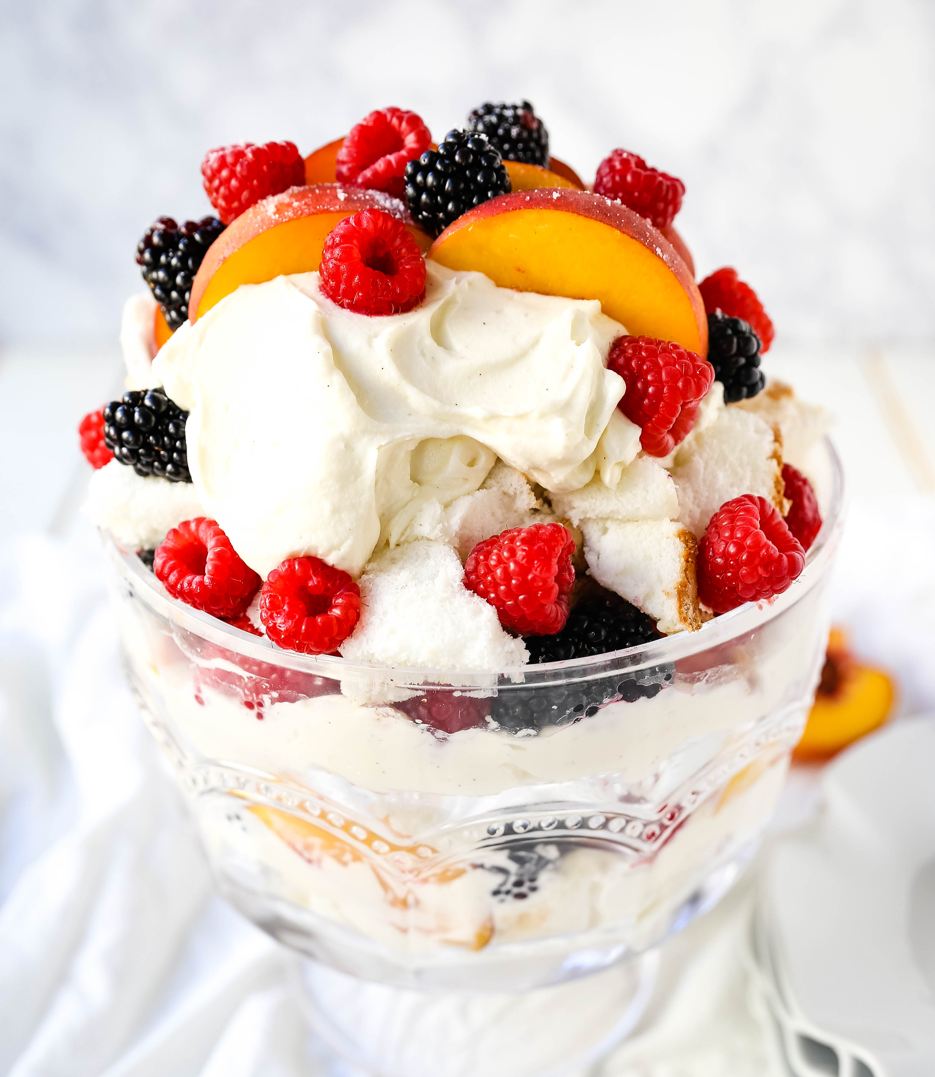 Peach Berry Trifle Angel food cake, a sweet, creamy, fluffy filling with fresh peaches and raspberries makes this the perfect summer dessert.  www.modernhoney.com #peach #peacherecipes #trifle #dessert