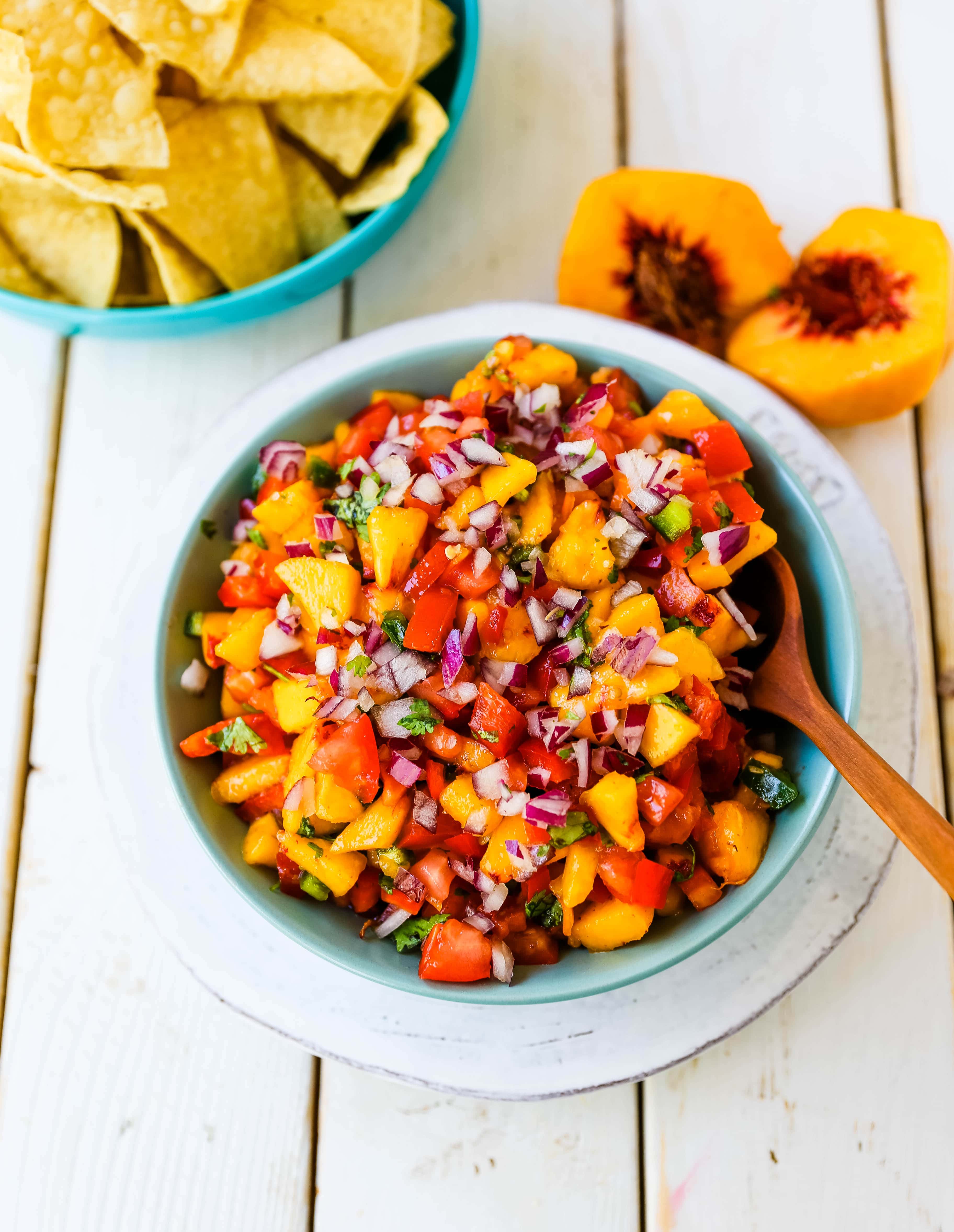 Peach Salsa. Fresh peach salsa with red pepper, jalapeño, red onion, tomatoes, cilantro, and fresh lime juice. A sweet and savory salsa perfect to pair with chips, grilled chicken or pork. www.modernhoney.com #peachsalsa #salsa #peachrecipes