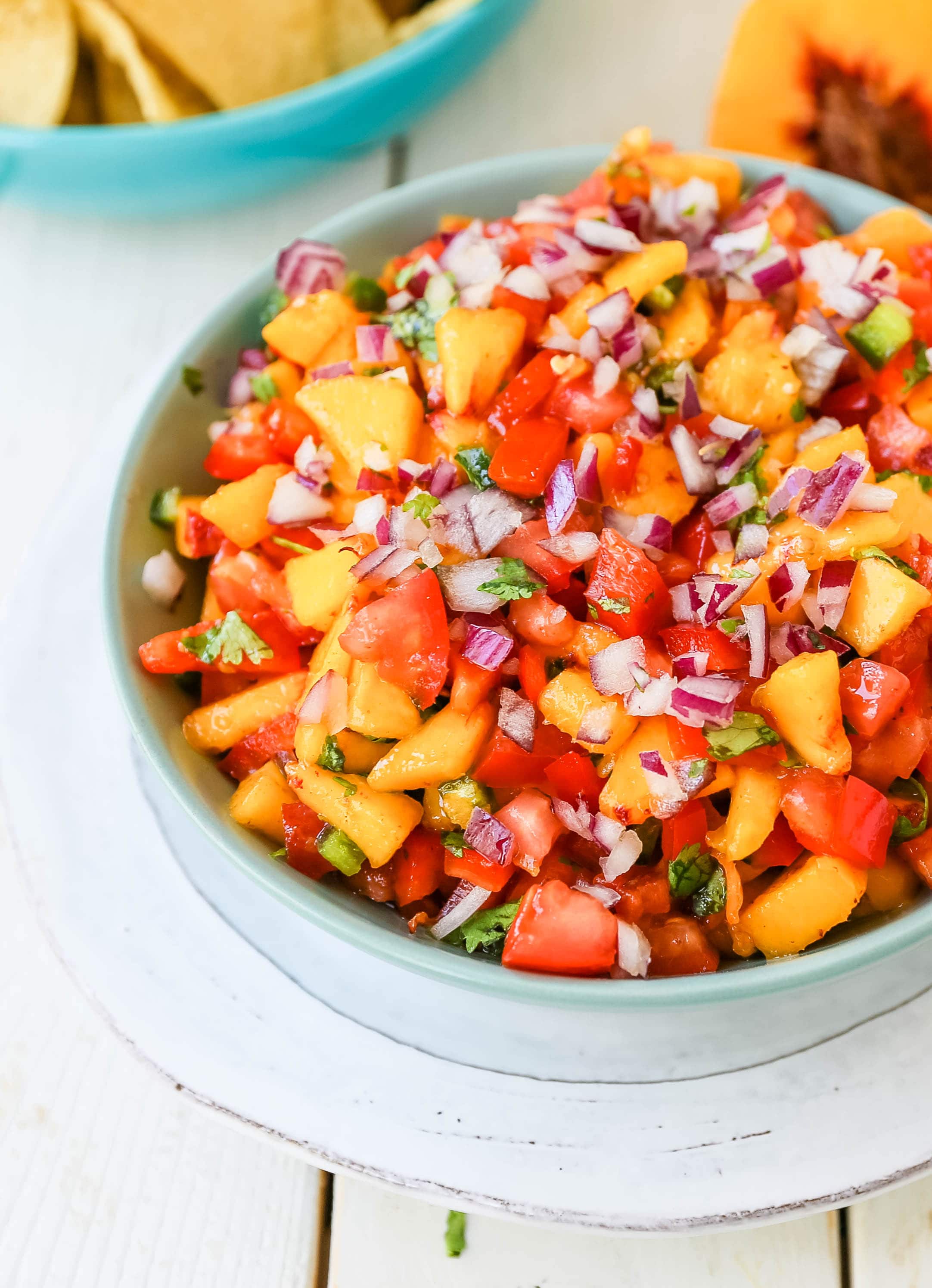 Peach Salsa. Fresh peach salsa with red pepper, jalapeño, red onion, tomatoes, cilantro, and fresh lime juice. A sweet and savory salsa perfect to pair with chips, grilled chicken or pork. www.modernhoney.com #peachsalsa #salsa #peachrecipes