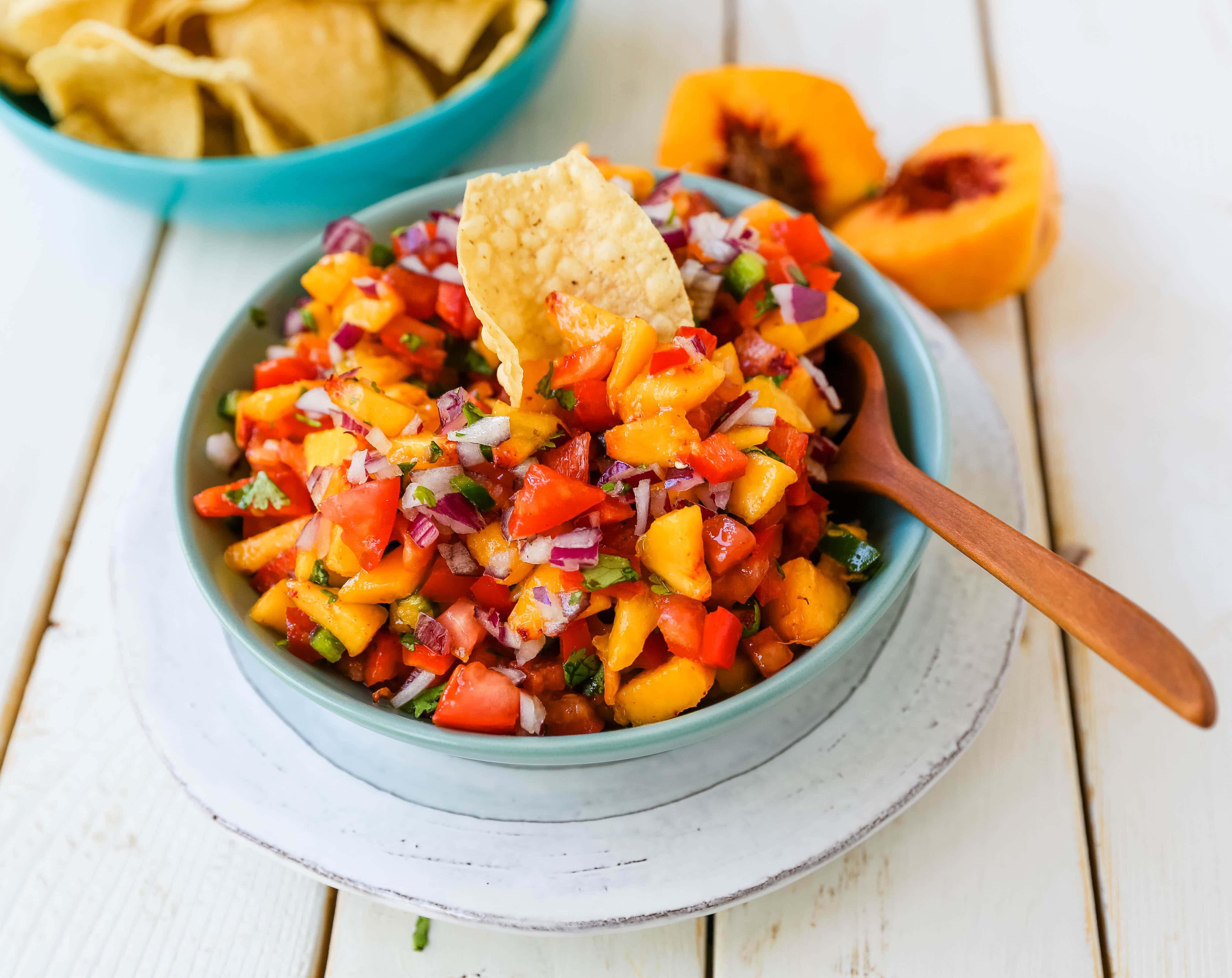 Peach Salsa. Fresh peach salsa with red pepper, jalapeño, red onion, tomatoes, cilantro, and fresh lime juice. A sweet and savory salsa perfect to pair with chips, grilled chicken or pork. www.modernhoney.com #peachsalsa #salsa #peachrecipes