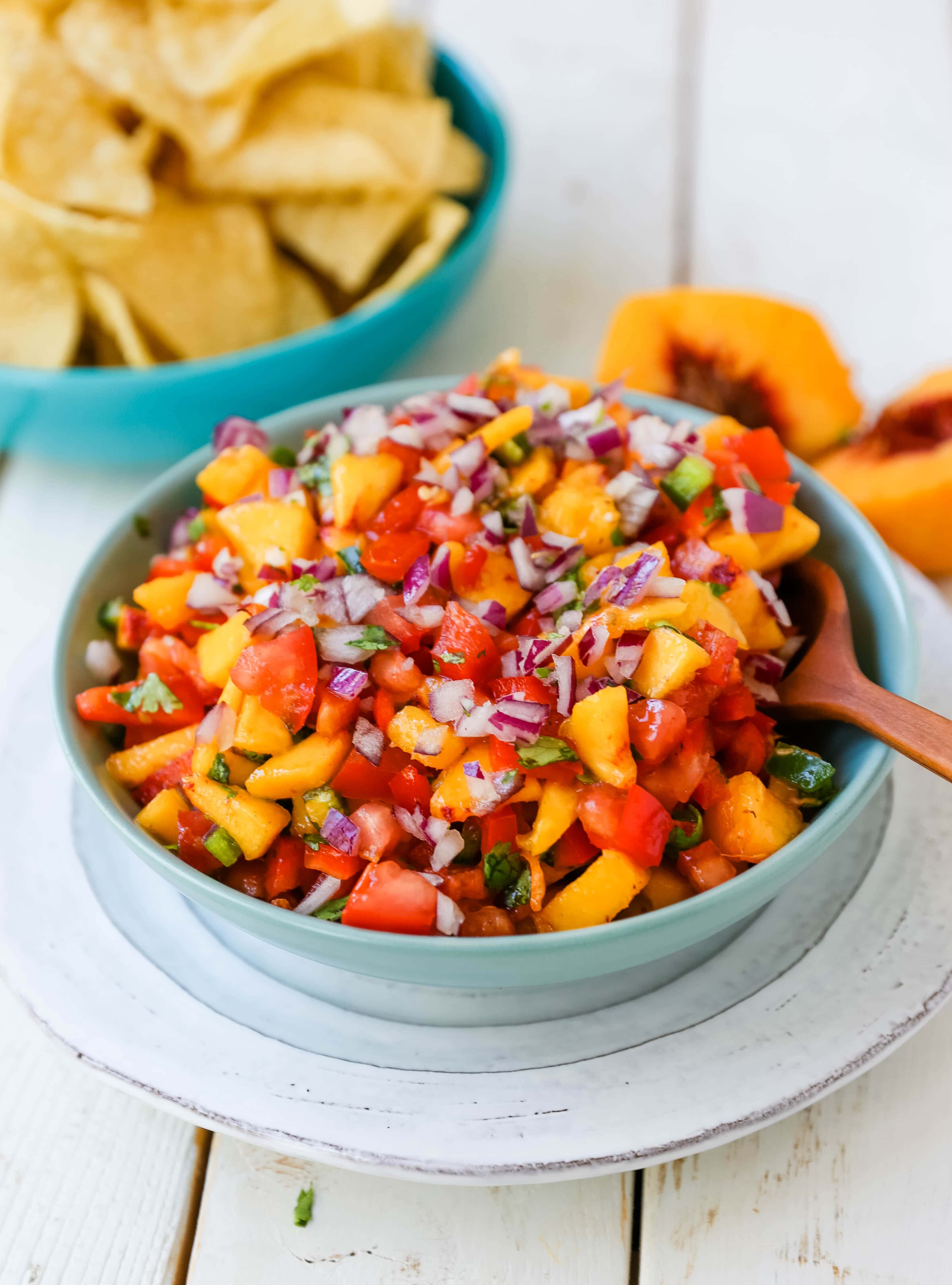 Peach Salsa. Fresh peach salsa with red pepper, jalapeño, red onion, tomatoes, cilantro, and fresh lime juice. A sweet and savory salsa perfect to pair with chips, grilled chicken or pork. www.modernhoney.com #peachsalsa #salsa #peachrecipes