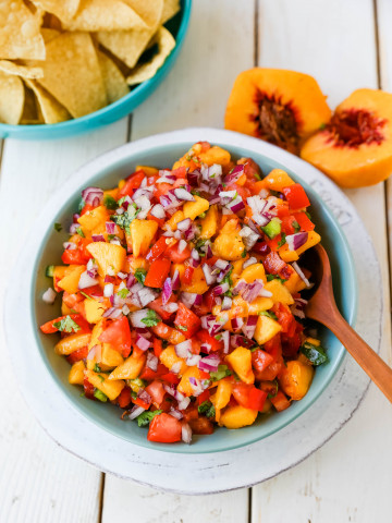 Peach Salsa. Fresh peach salsa with red pepper, jalapeño, red onion, tomatoes, cilantro, and fresh lime juice. A sweet and savory salsa perfect to pair with chips, grilled chicken or pork. www.modernhoney.com #peachsalsa #salsa #peachrecipes