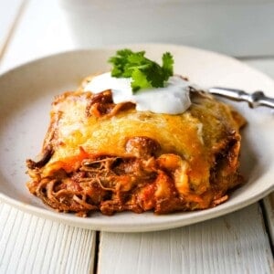 Stacked Beef Enchiladas. Mexican seasoned shredded beef enchiladas with melted cheese, corn tortillas, and homemade enchilada sauce. An easy beef enchilada casserole! #mexican #mexicanfood #enchiladas #beefenchiladas