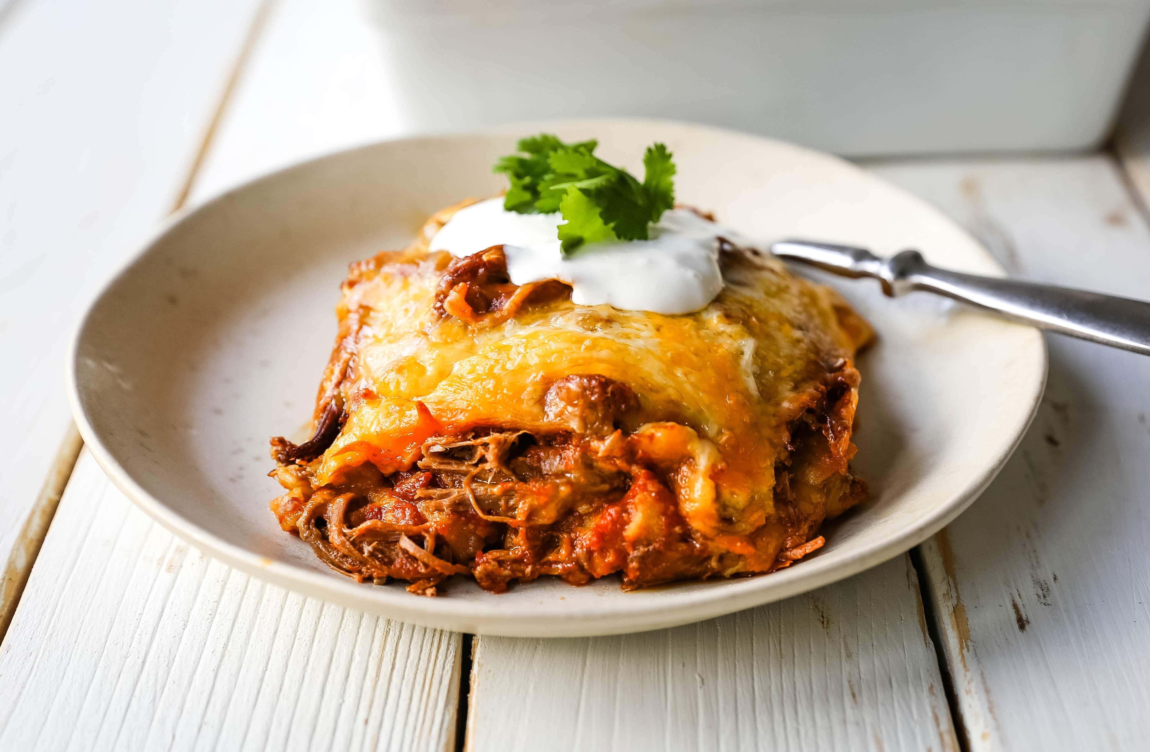 Stacked Beef Enchiladas. Mexican seasoned shredded beef enchiladas with melted cheese, corn tortillas, and homemade enchilada sauce. An easy beef enchilada casserole! #mexican #mexicanfood #enchiladas #beefenchiladas