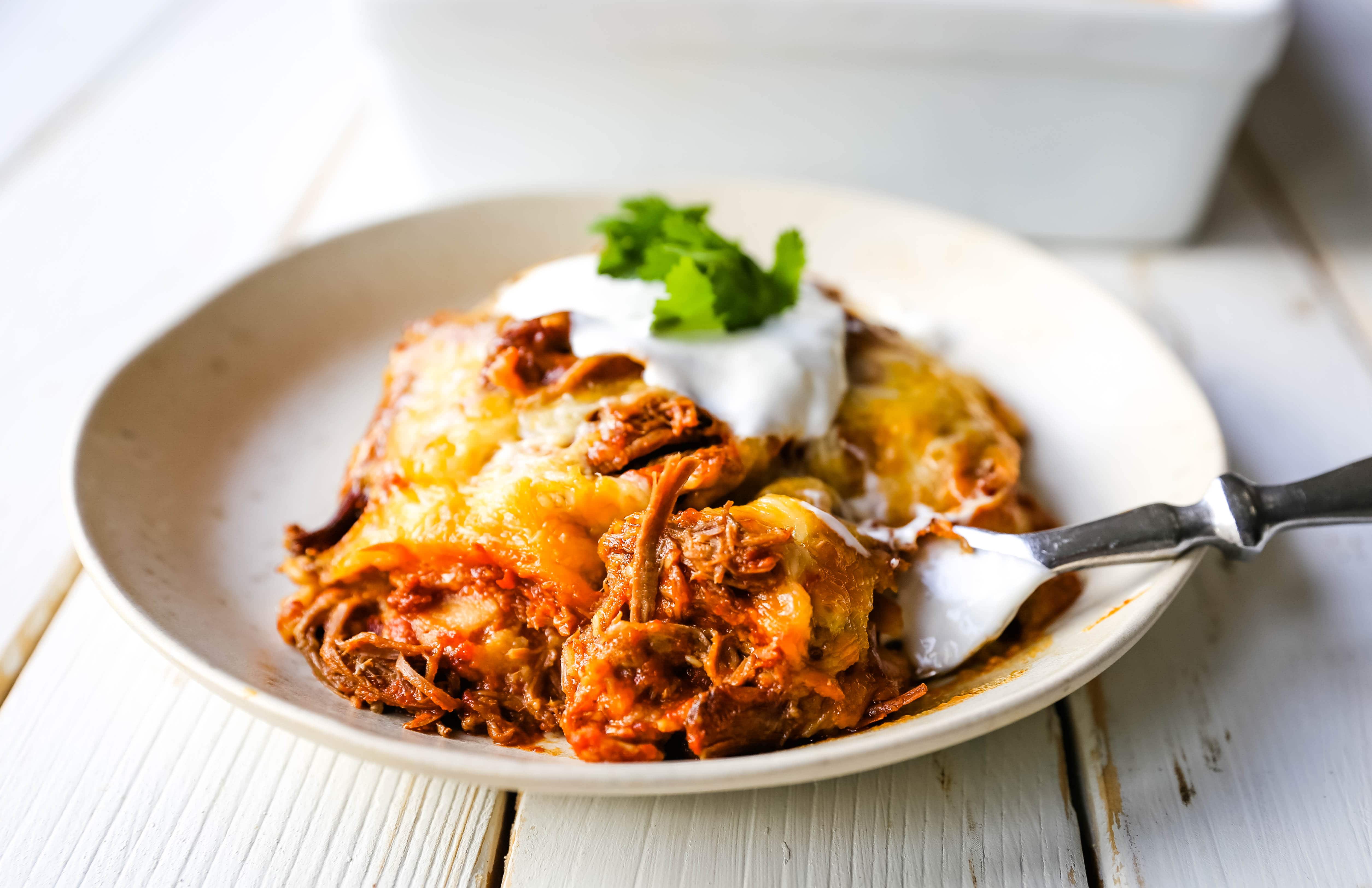 Stacked Beef Enchiladas. Mexican seasoned shredded beef enchiladas with melted cheese, corn tortillas, and homemade enchilada sauce. An easy beef enchilada casserole! #mexican #mexicanfood #enchiladas #beefenchiladas