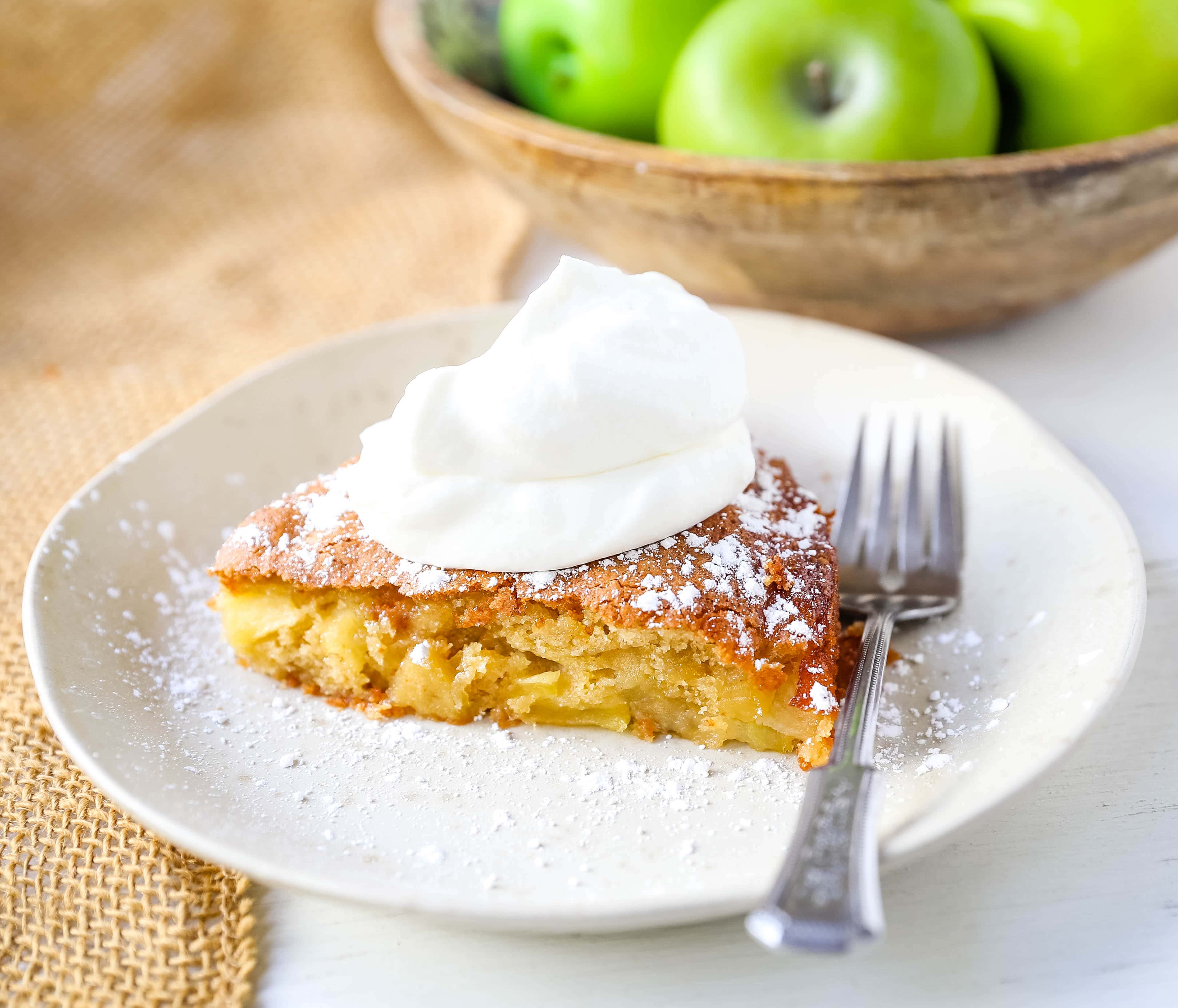 French Apple Cake A simple French buttery cake made with sweet apples and topped with freshly whipped cream. www.modernhoney.com #frenchapplecake #applecake #frenchcake #dessert #appledessert