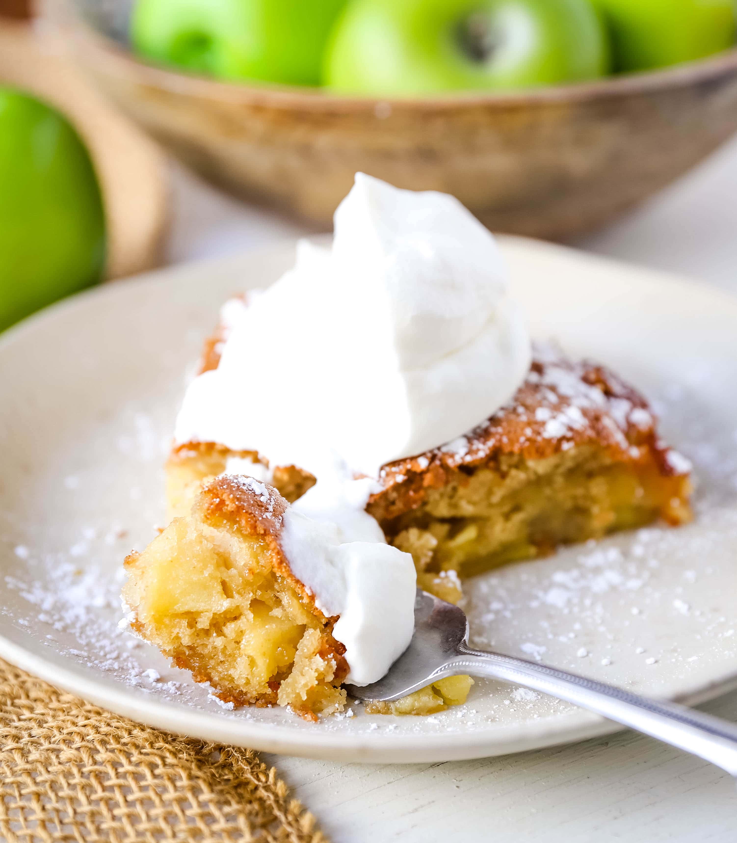 French Apple Cake A simple French buttery cake made with sweet apples and topped with freshly whipped cream. www.modernhoney.com #frenchapplecake #applecake #frenchcake #dessert #appledessert