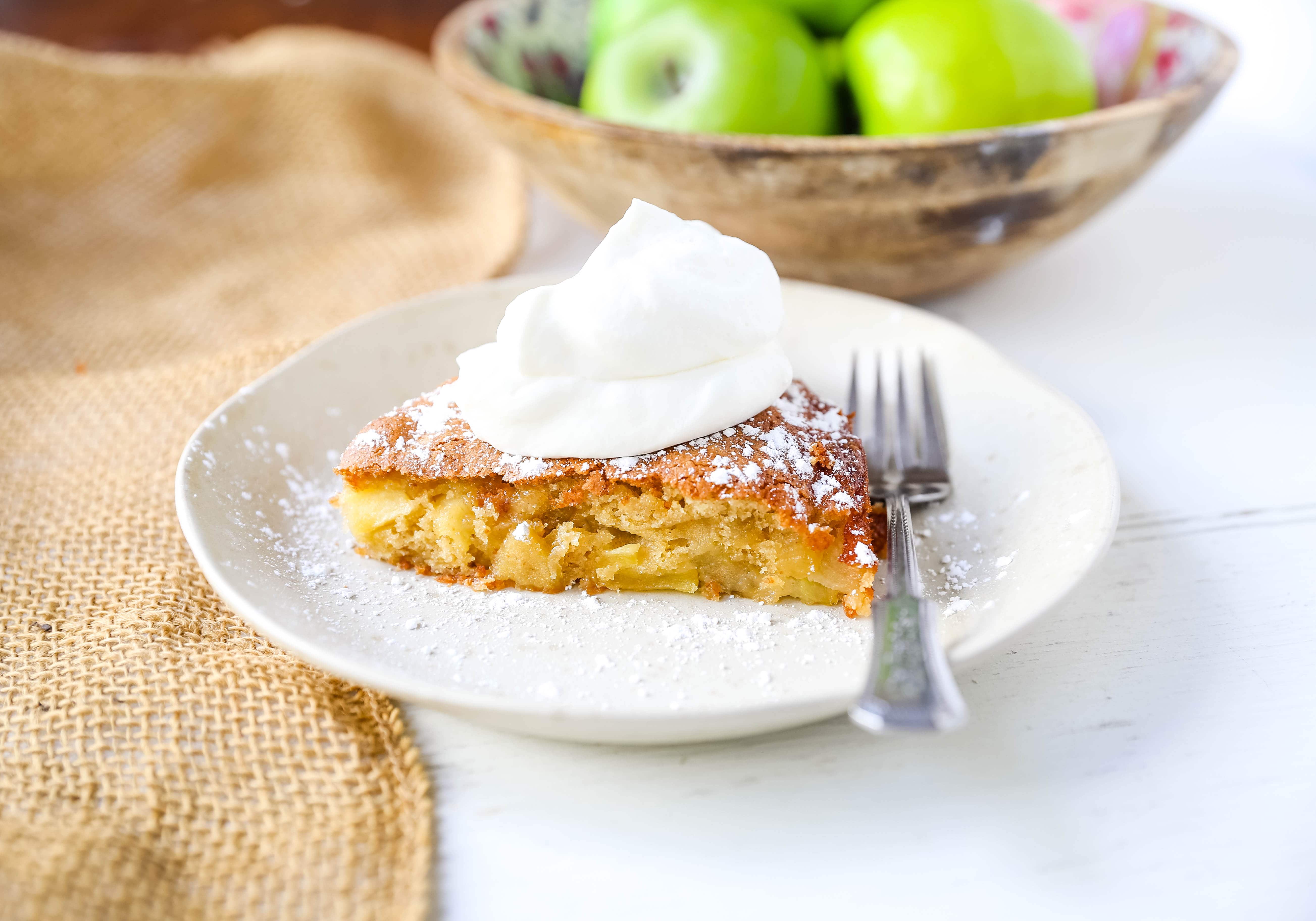 French Apple Cake A simple French buttery cake made with sweet apples and topped with freshly whipped cream. www.modernhoney.com #frenchapplecake #applecake #frenchcake #dessert #appledessert