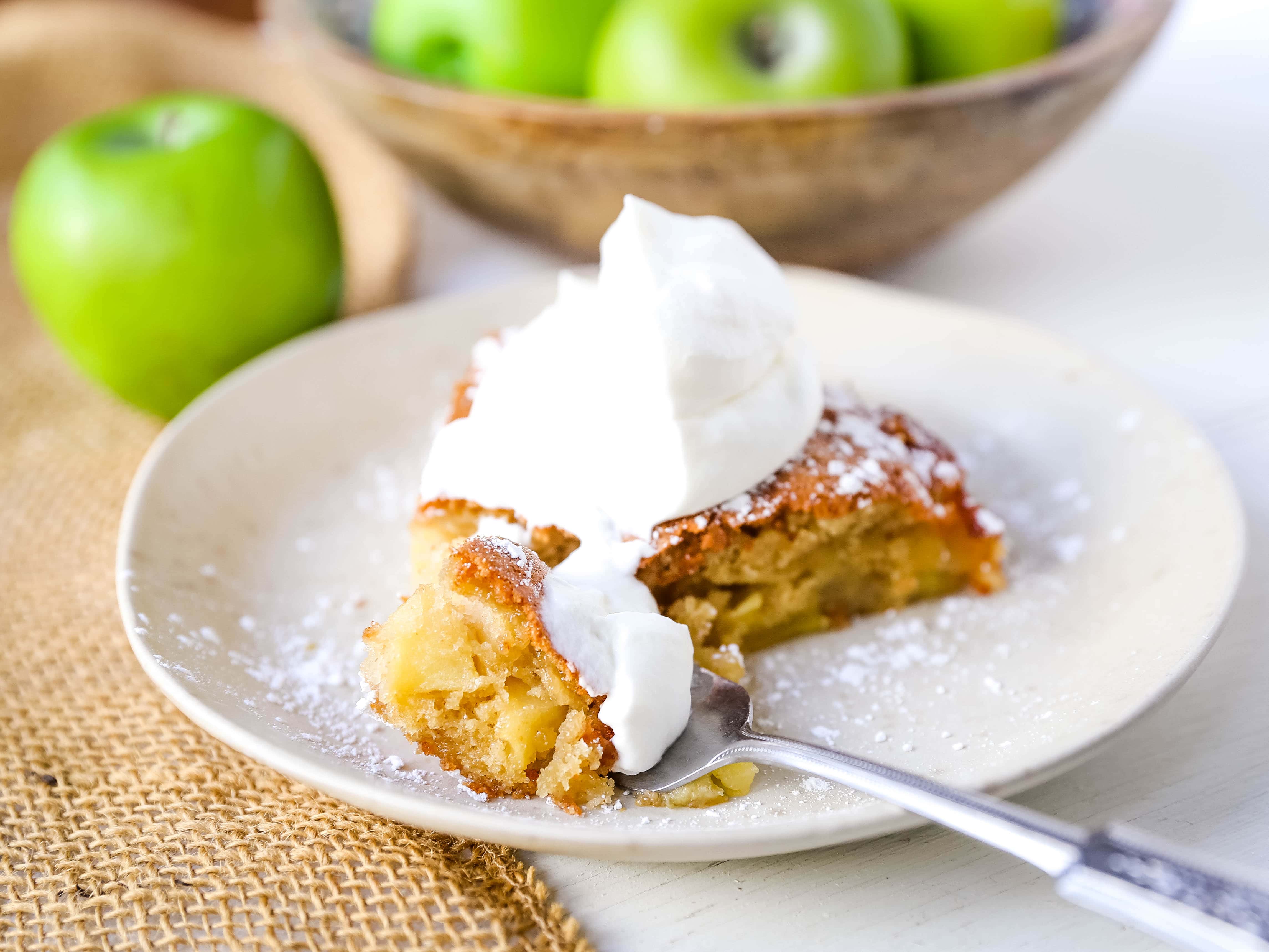 French Apple Cake A simple French buttery cake made with sweet apples and topped with freshly whipped cream. www.modernhoney.com #frenchapplecake #applecake #frenchcake #dessert #appledessert