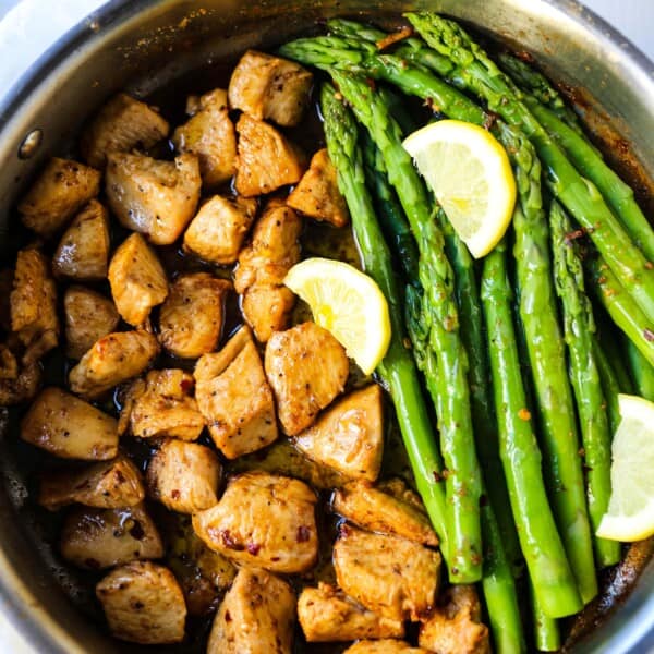 Garlic Butter Chicken and Asparagus Skillet A quick and easy one skillet dinner made with sautéed chicken and asparagus tossed in garlic butter. www.modernhoney.com #chicken #skilletdinner #chickendinner