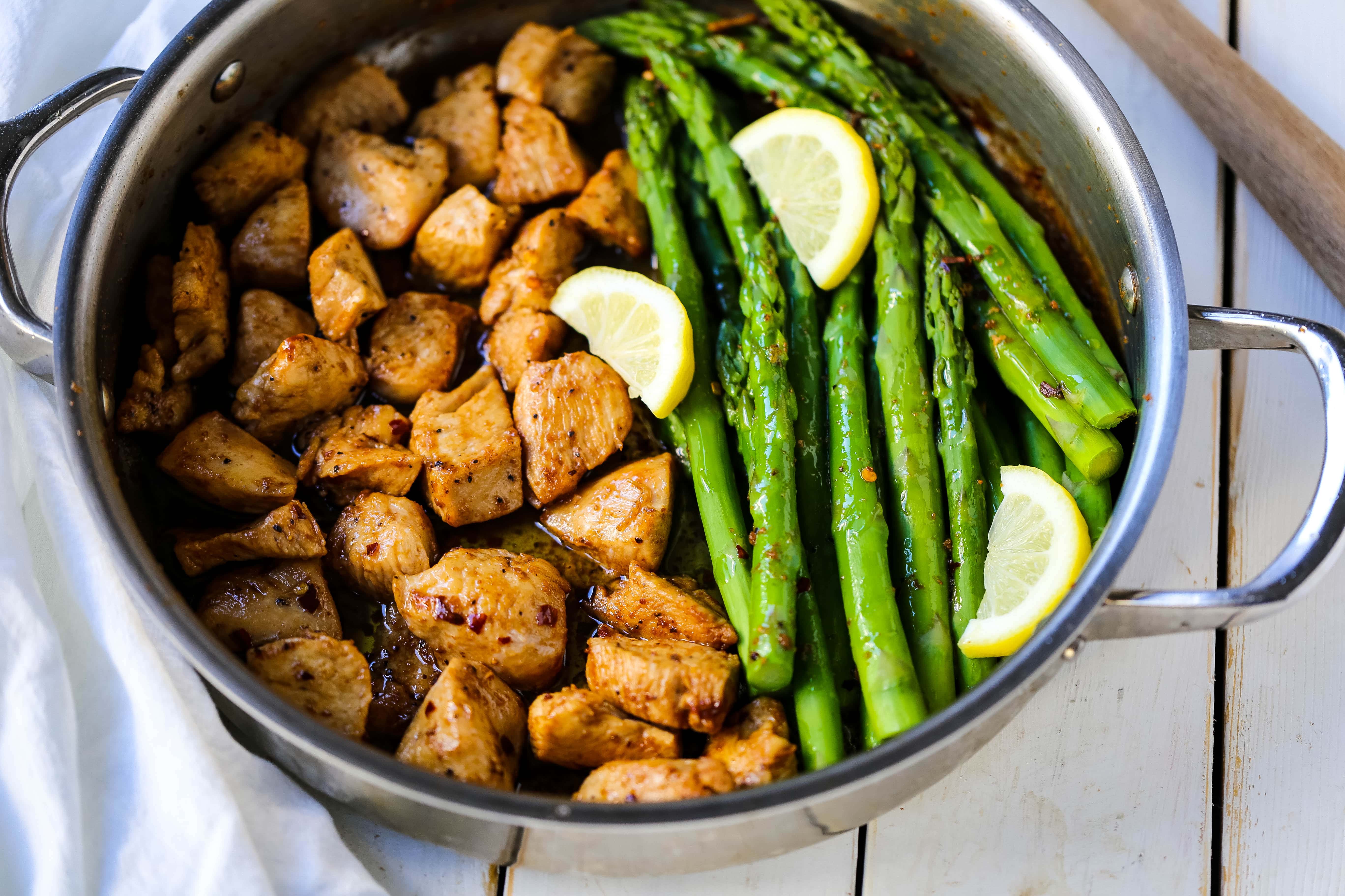 Garlic Butter Chicken and Asparagus Skillet A quick and easy one skillet dinner made with sautéed chicken and asparagus tossed in garlic butter. www.modernhoney.com #chicken #skilletdinner #chickendinner