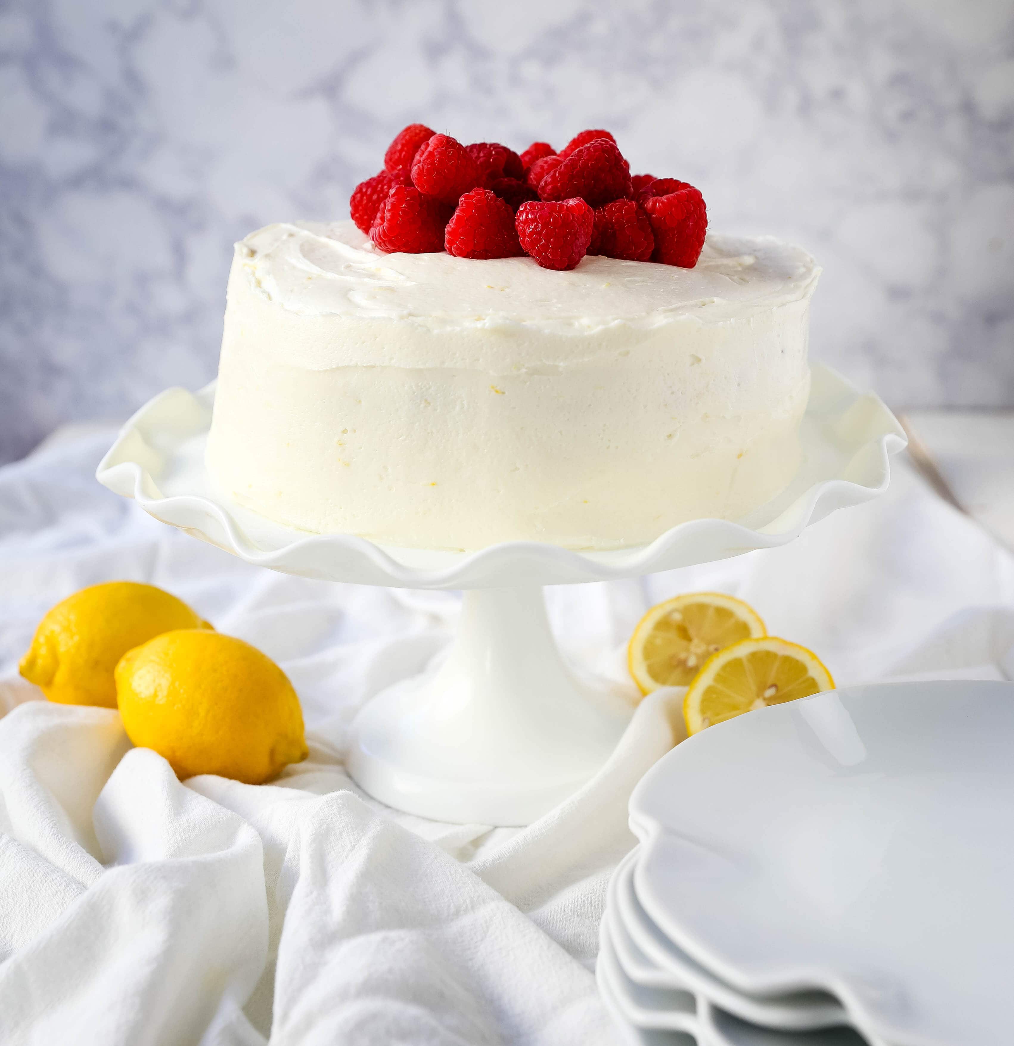 The Best Lemon Raspberry Cake. A light and fluffy lemon cake with fresh raspberries and a fresh lemon cream cheese frosting. A sweet and tangy lemon berry cake! #lemoncake #cake #lemonraspberrycake