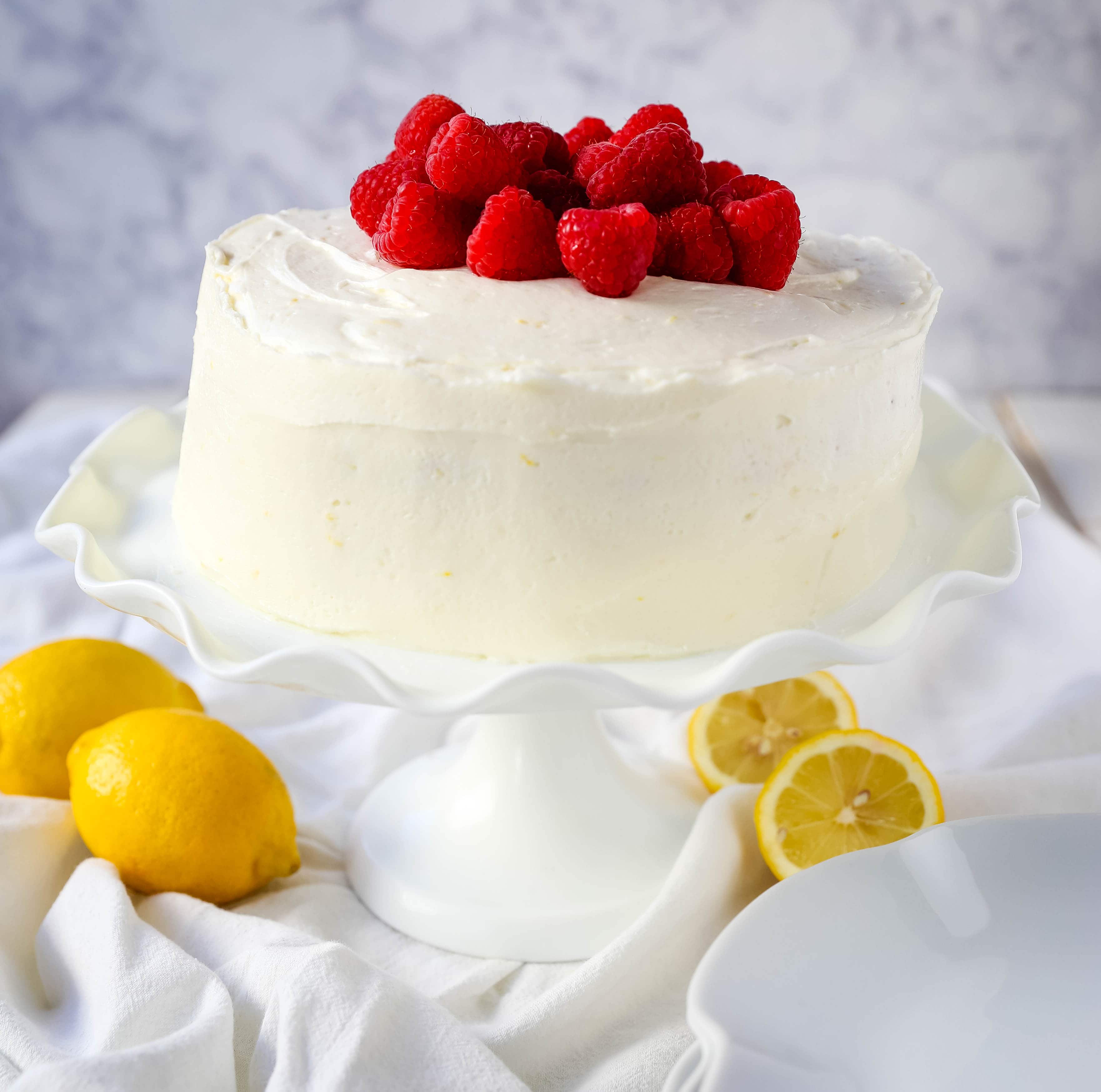 The Best Lemon Raspberry Cake. A light and fluffy lemon cake with fresh raspberries and a fresh lemon cream cheese frosting. A sweet and tangy lemon berry cake! #lemoncake #cake #lemonraspberrycake